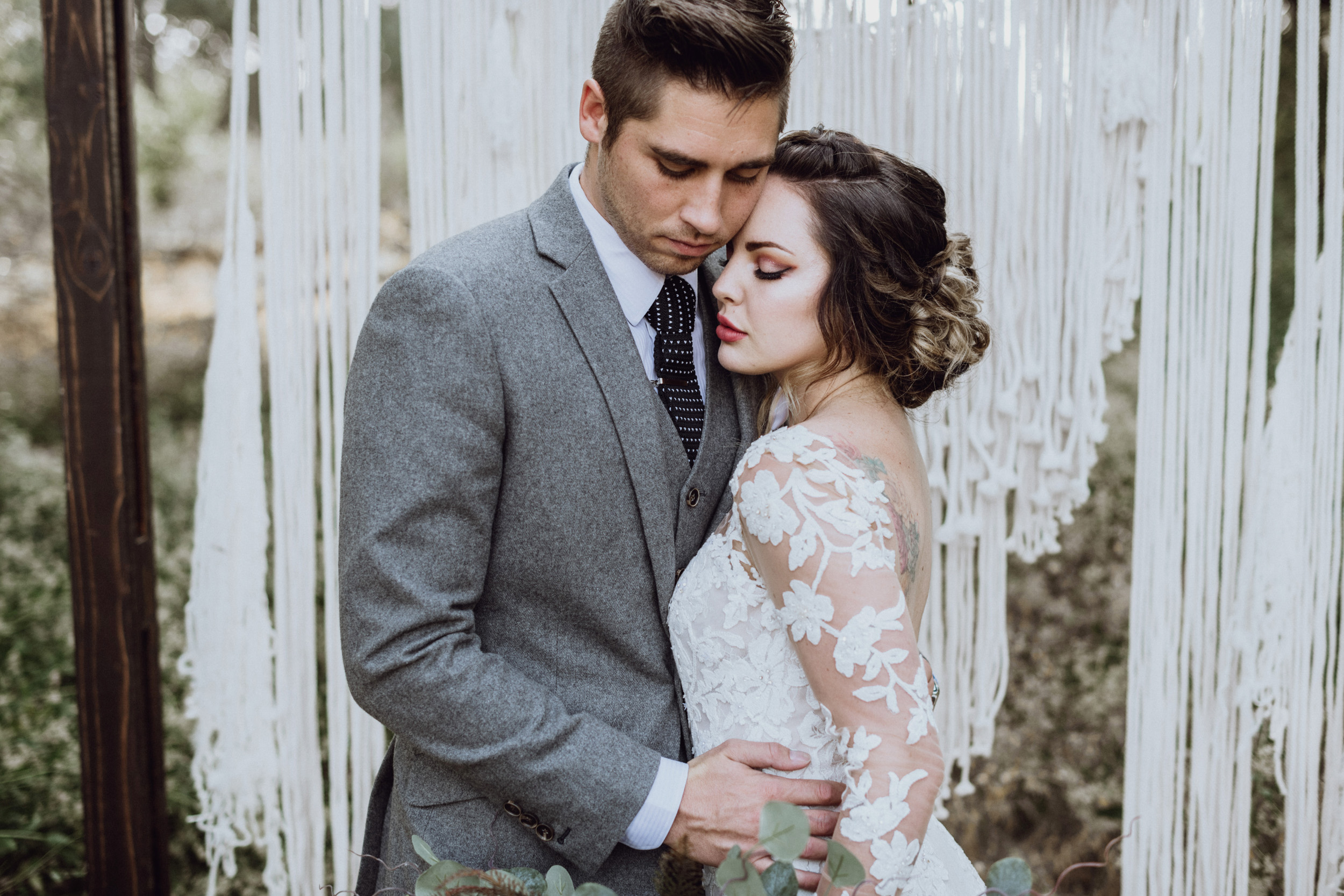 Bride and groom in front of boho Macrame at their Saratoga Springs Wedding