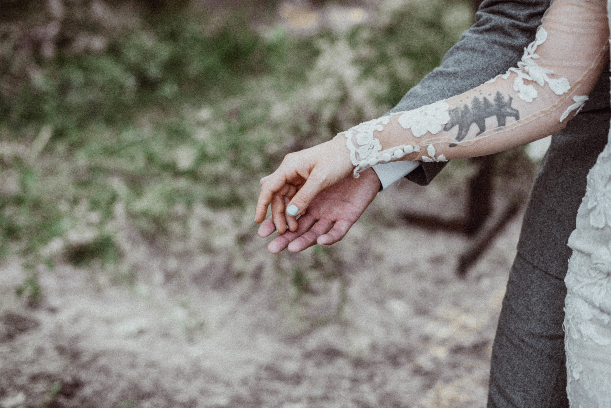 Lace wedding dress bear tattoo on forearm