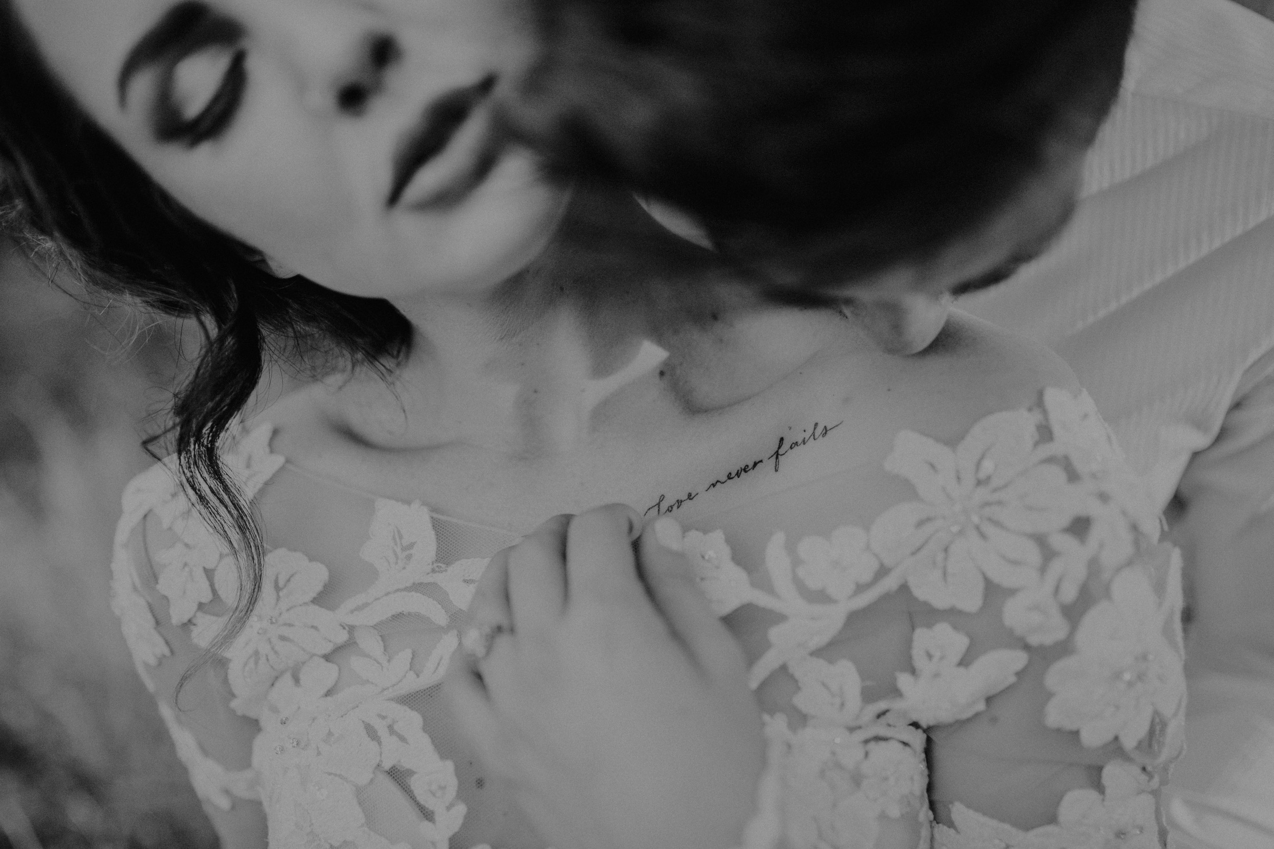 Bride in lace dress with collarbone tattoo