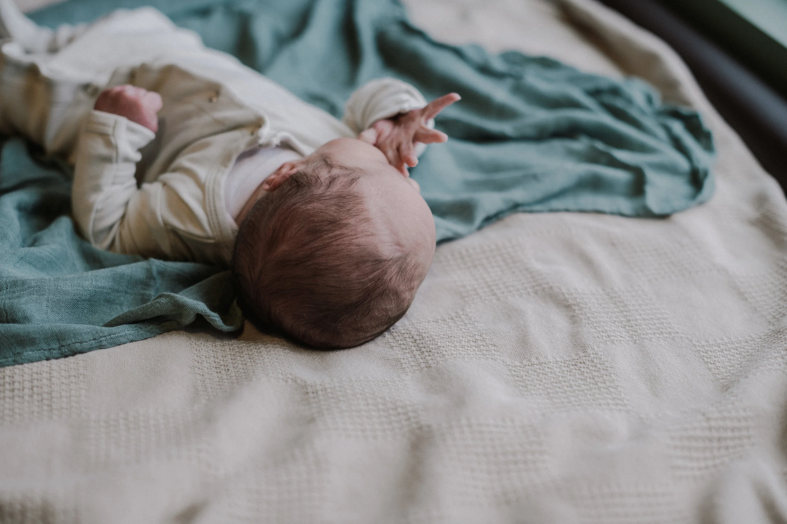 newborn baby details lying on blue receiving blanket