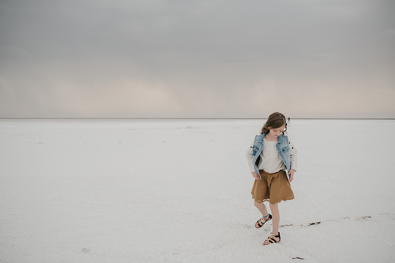 little girl in brown skirt on bonneville salt flats