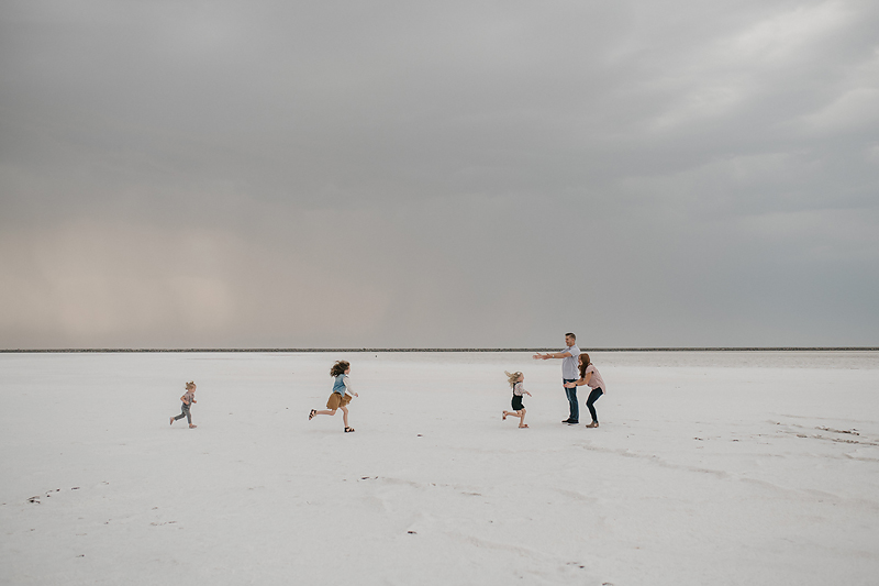 three little girls running to parents on the salt flats