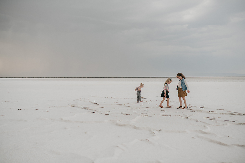 three sisters playing on the salt flats