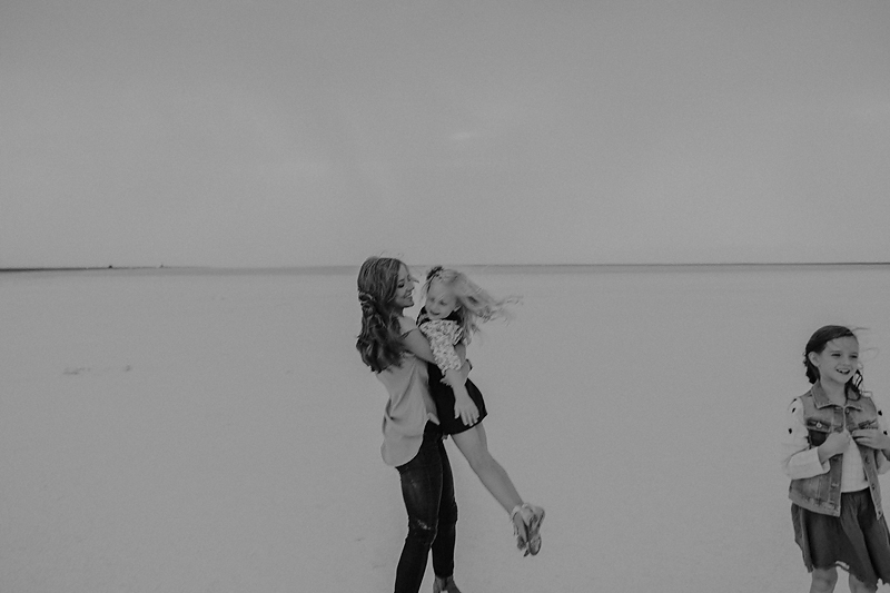 mom swinging little girl around