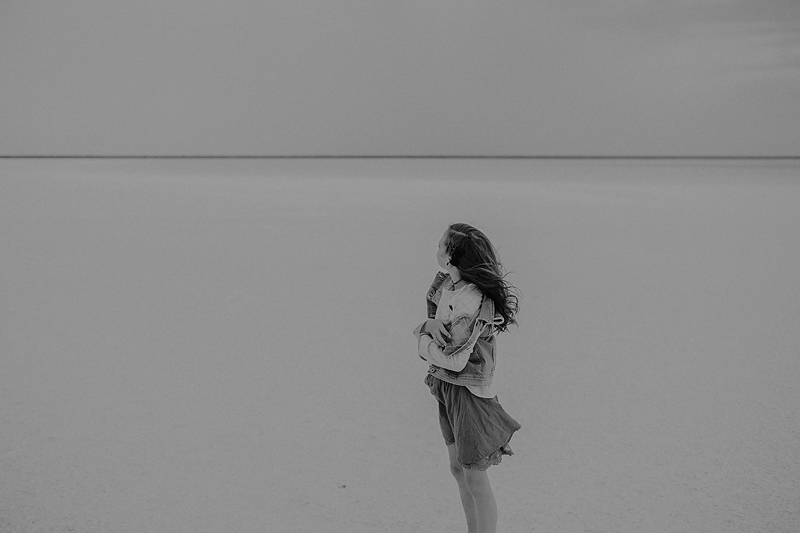 little girl in skirt with wind blowing through her hair