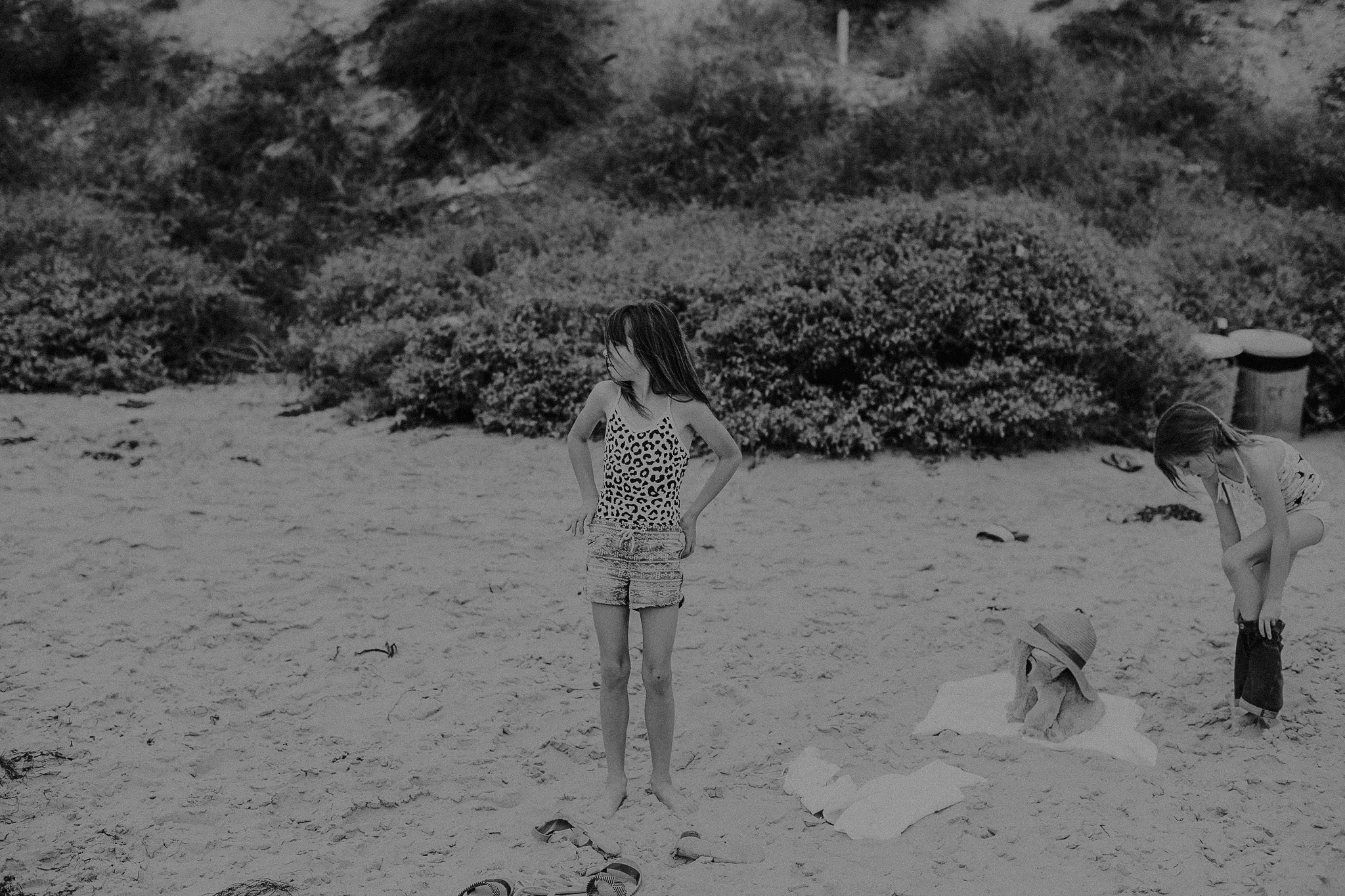 Mom and daughters sitting on the beach