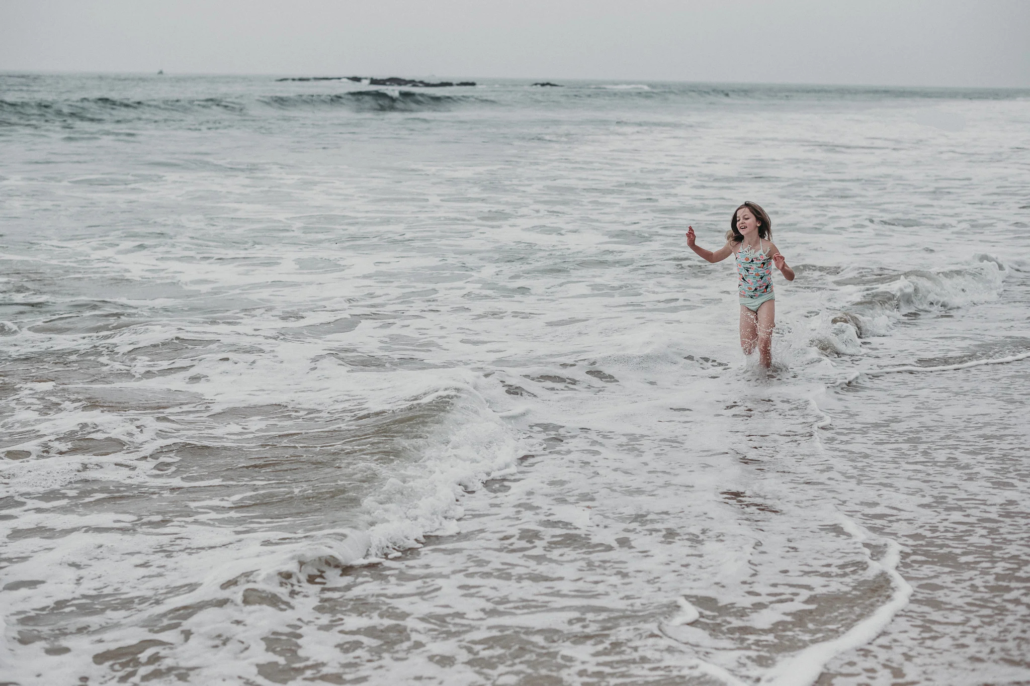 Little girl playing in shallow water