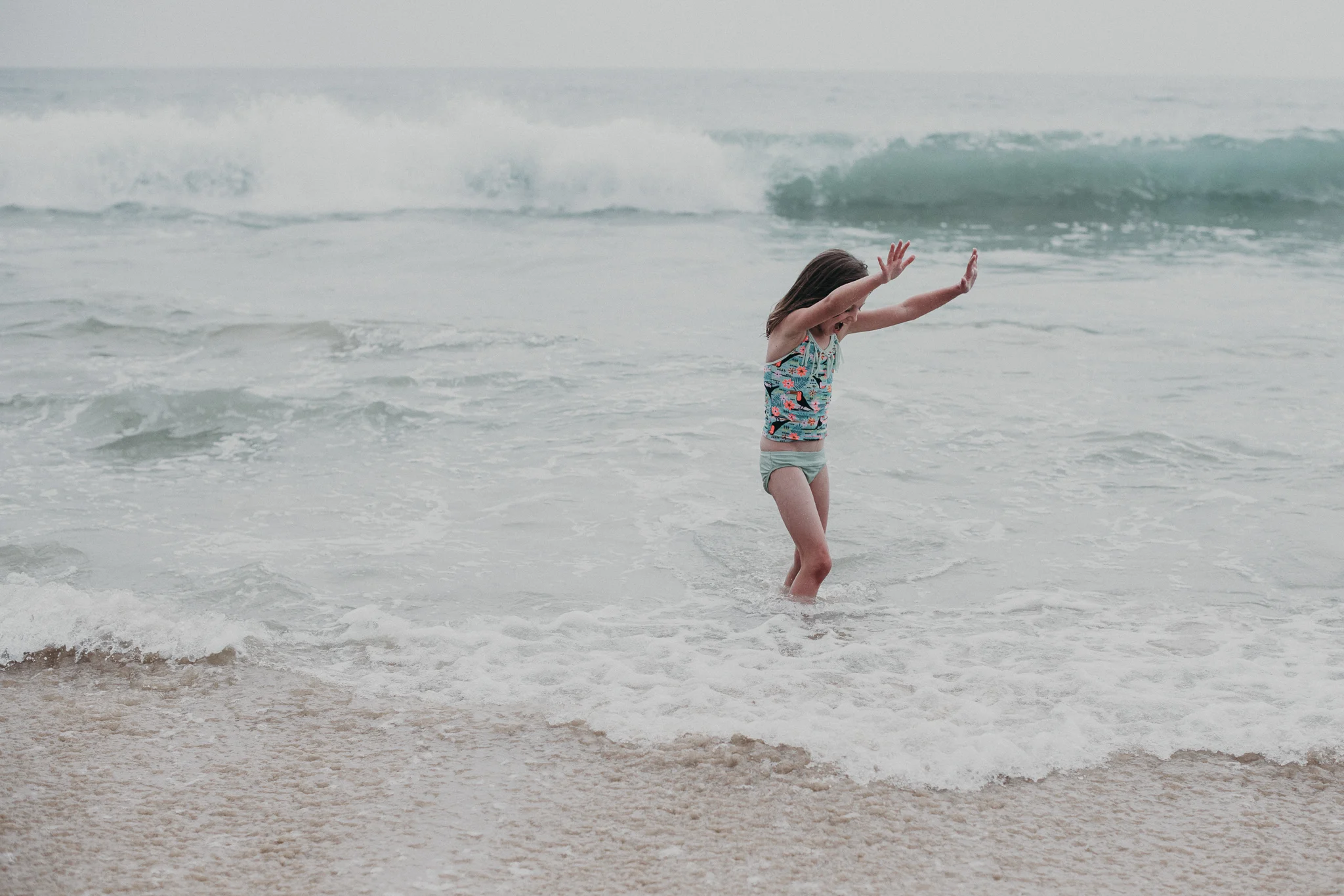 Little girl playing in shallow water