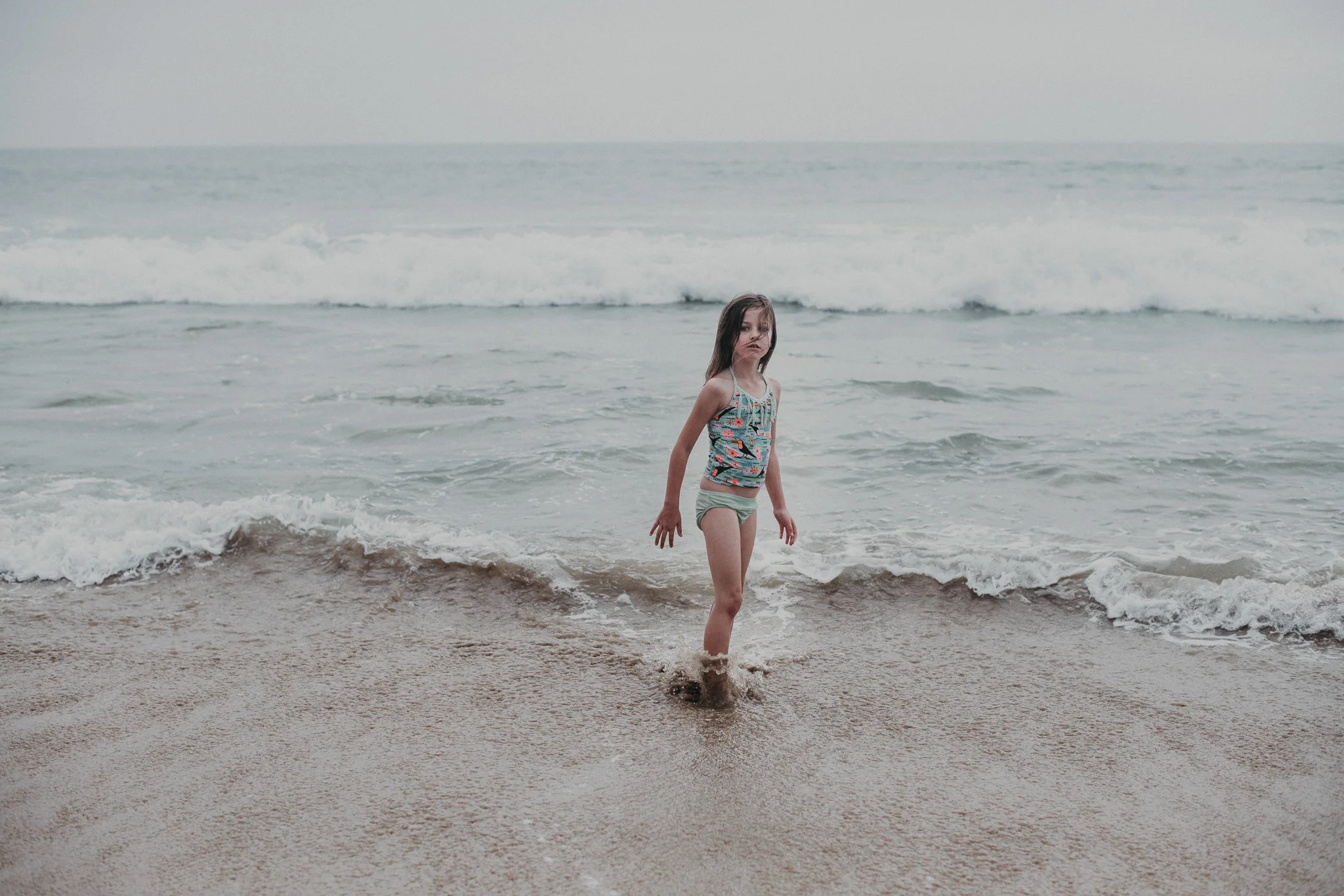 Little girl playing in shallow water