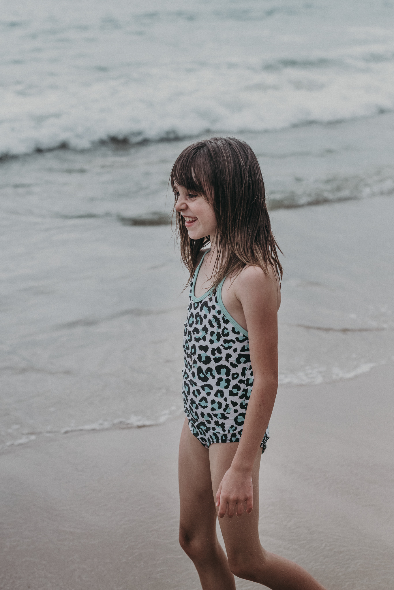 Little girl playing along the beach 