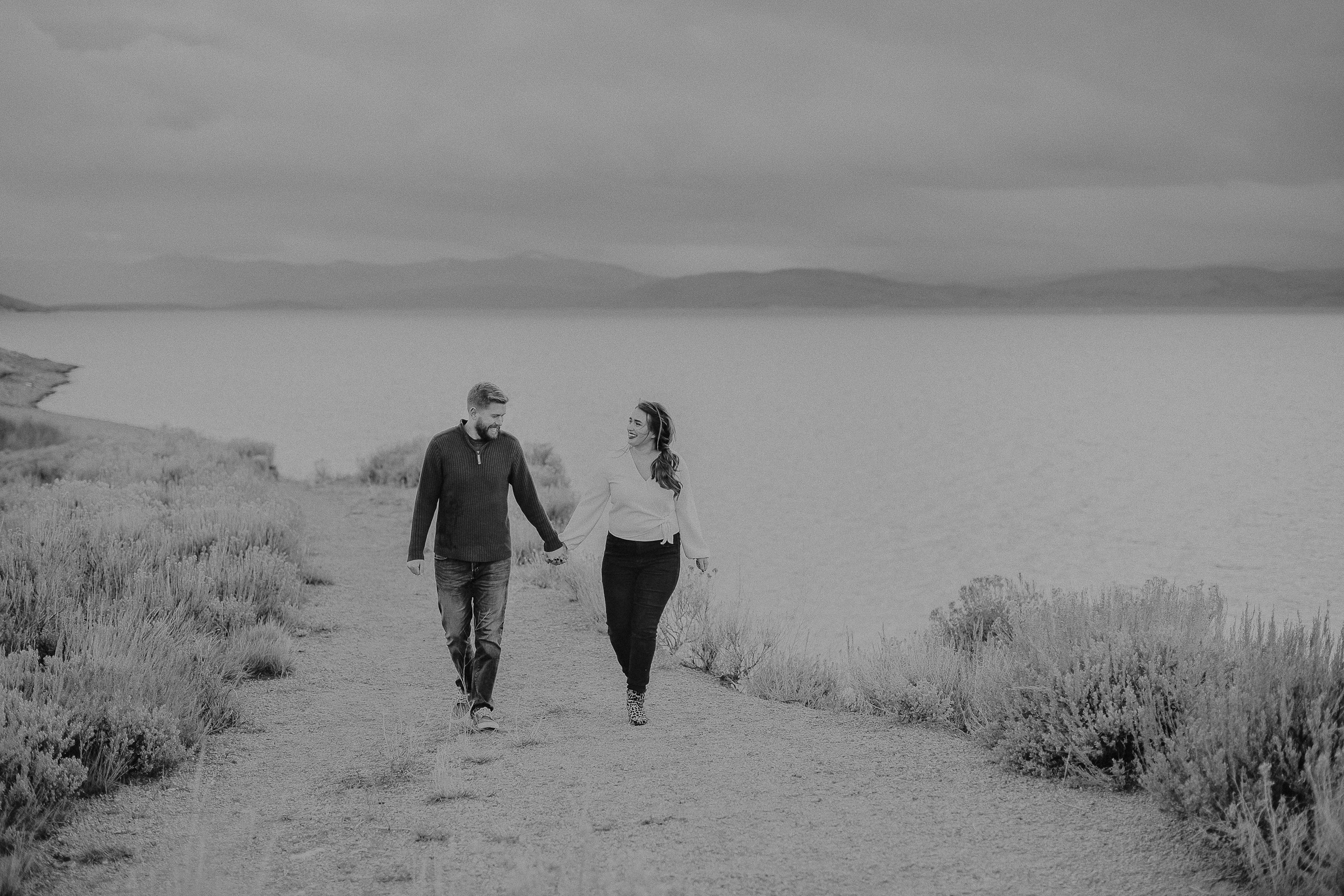 Couple in mountains looking over water 