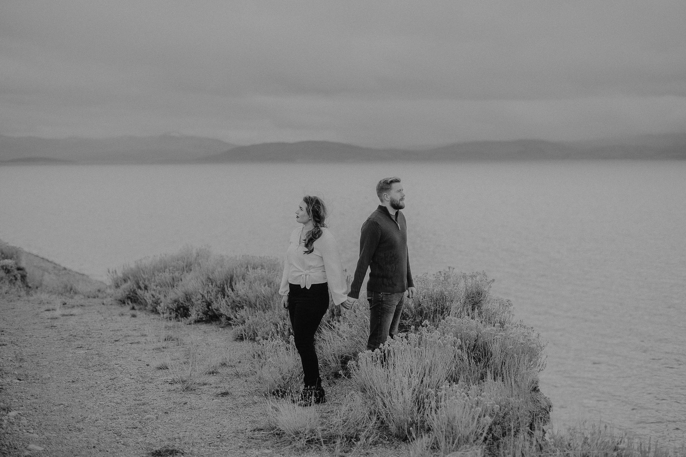 Couple in mountains looking over water