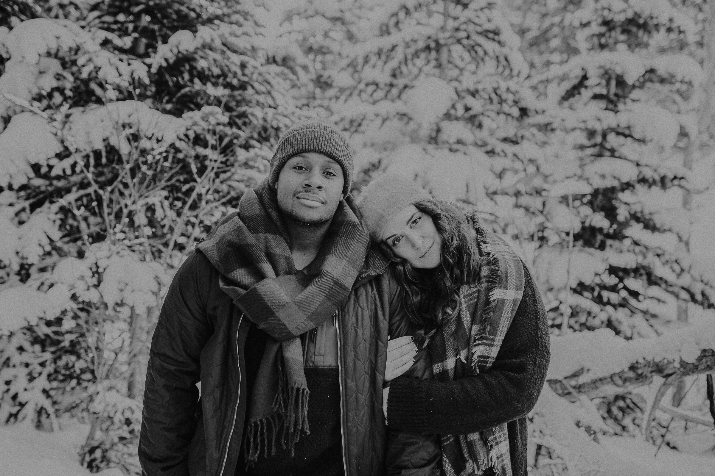 Couple standing together in snowy mountains