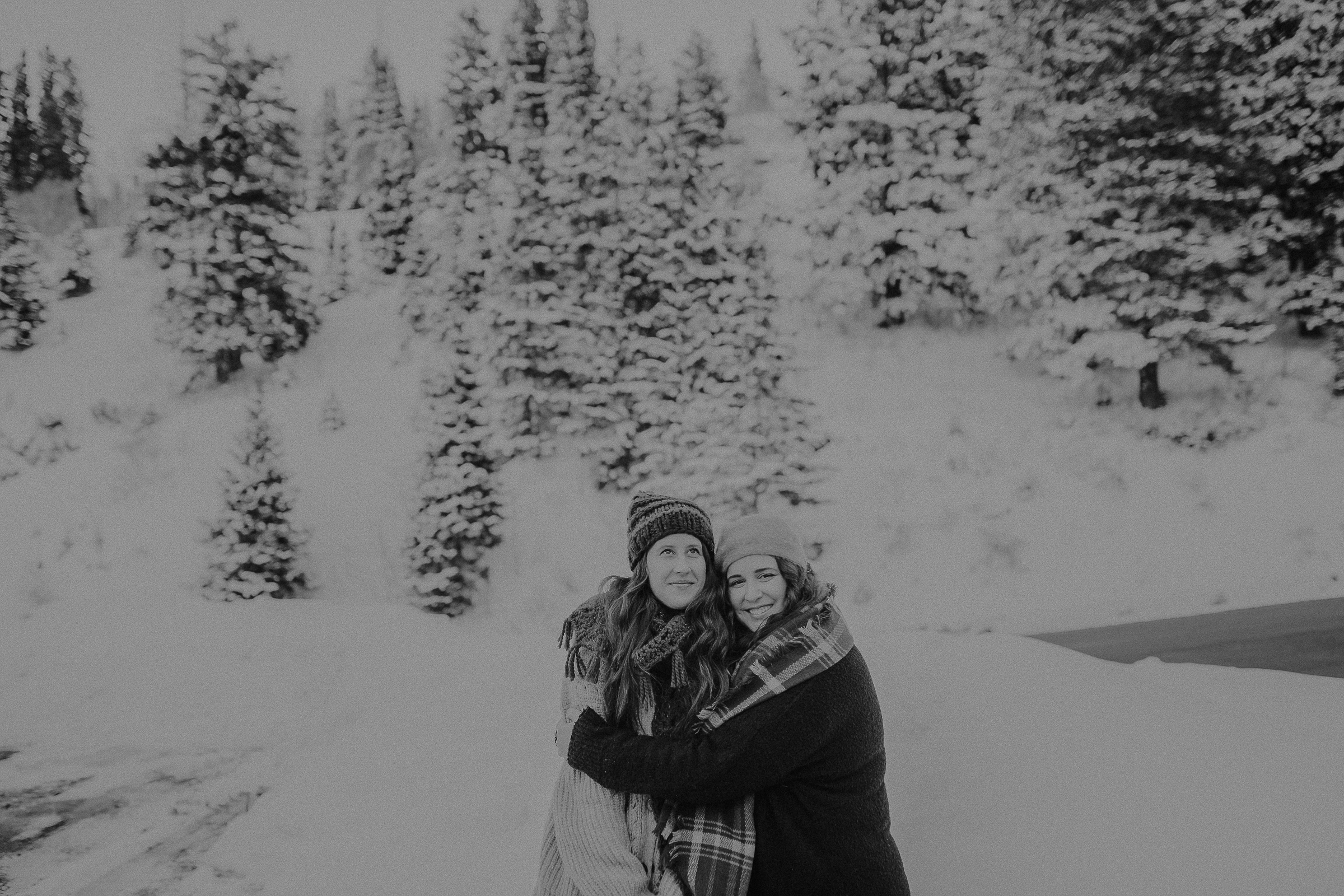 Sisters standing . together in snowy mountains 