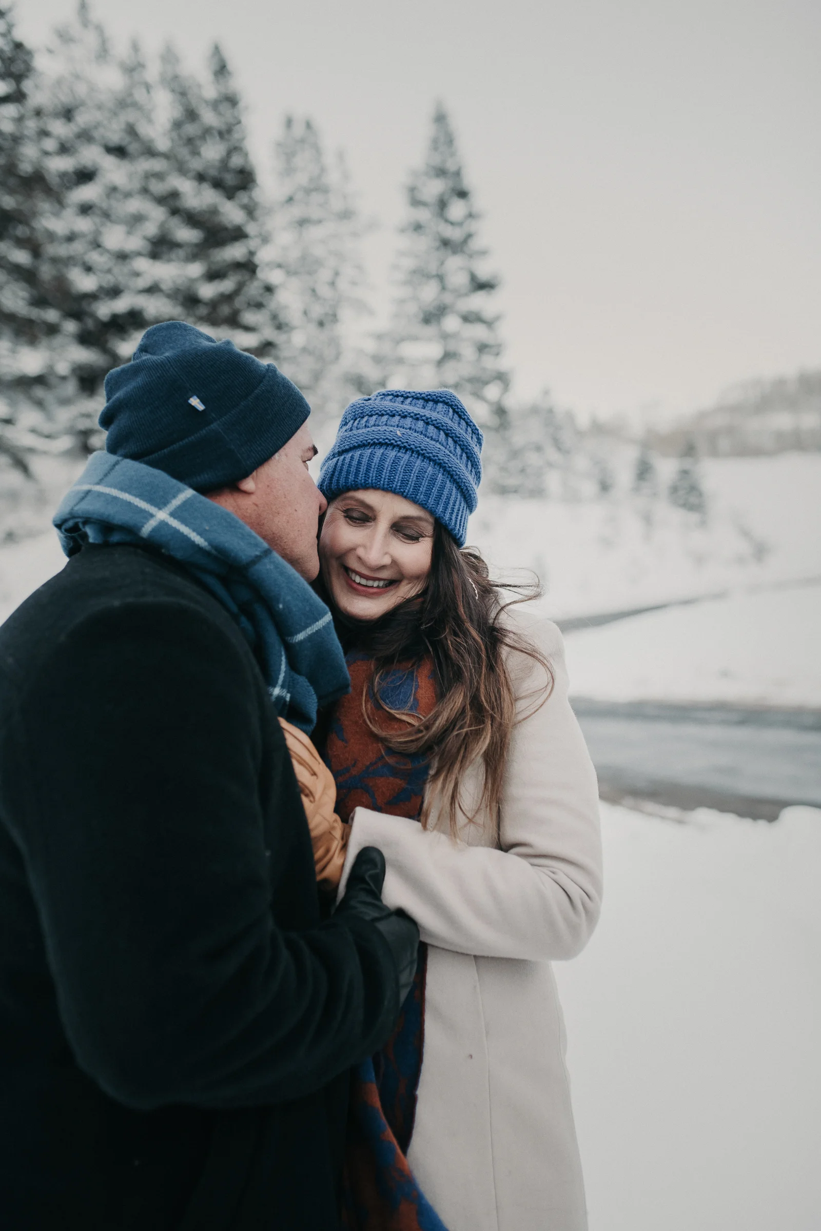 Couple standing together in snowy mountains