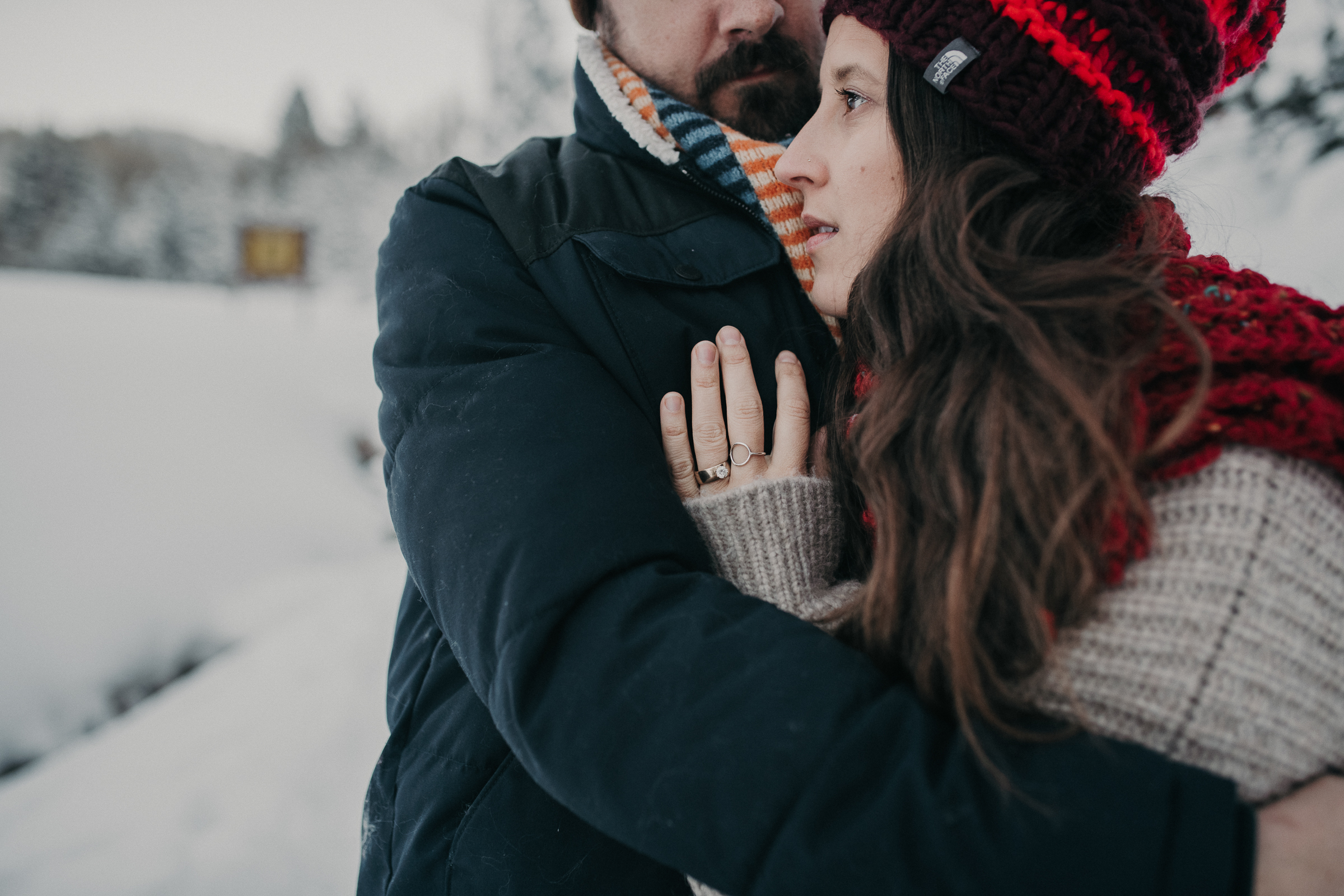 Couple standing together in snowy mountains 