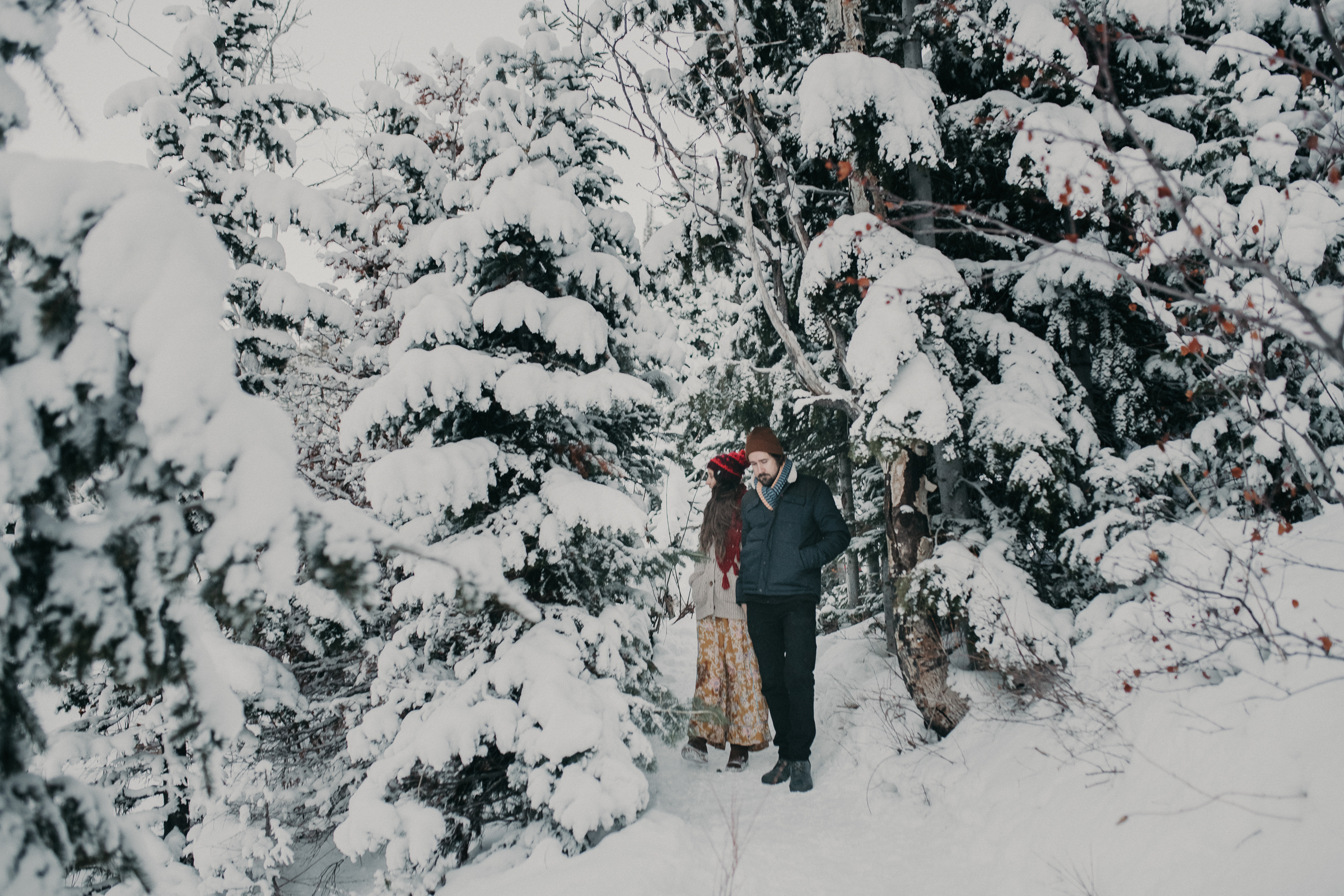 Couple standing together in snowy mountains 