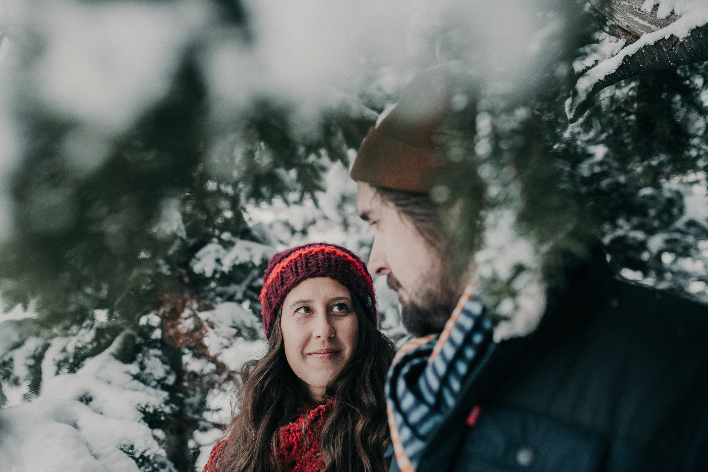 Couple standing together in snowy mountains 
