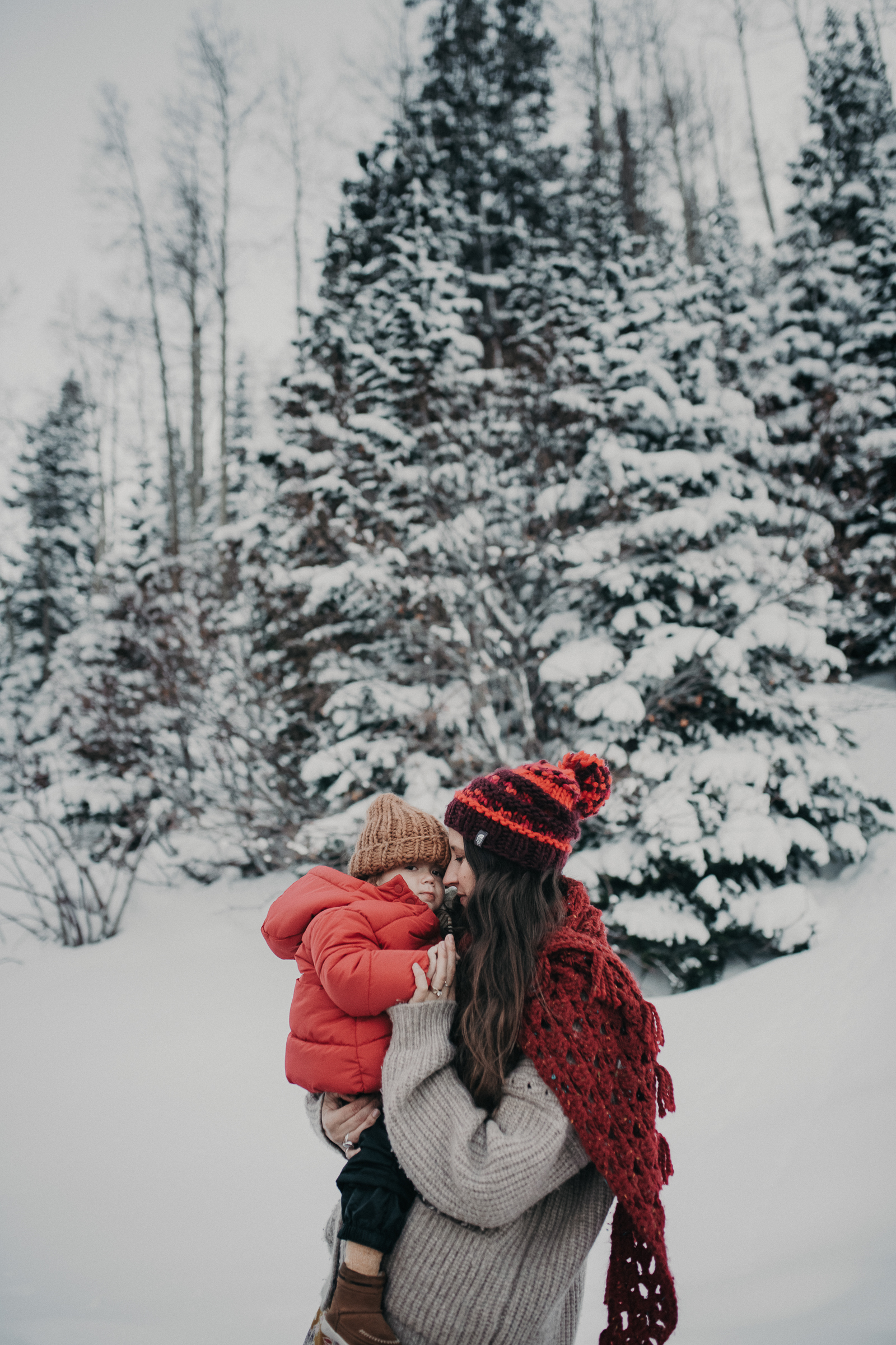 Mom and son in snowy mountains 