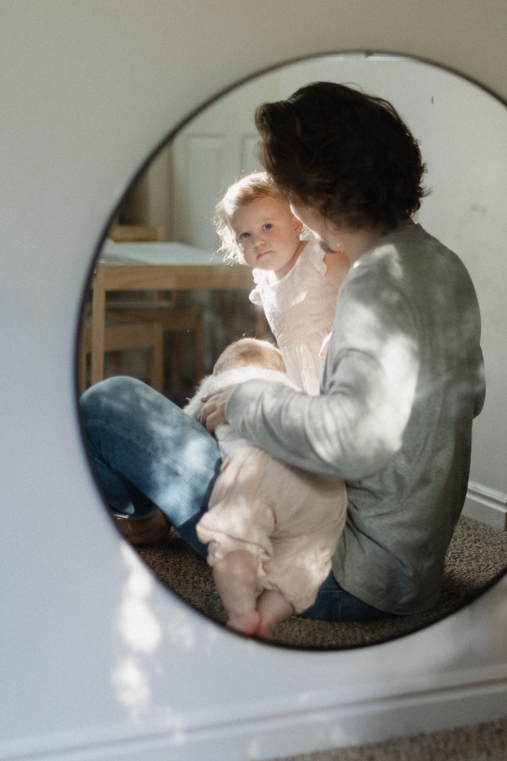 reflection of baby in round mirror
