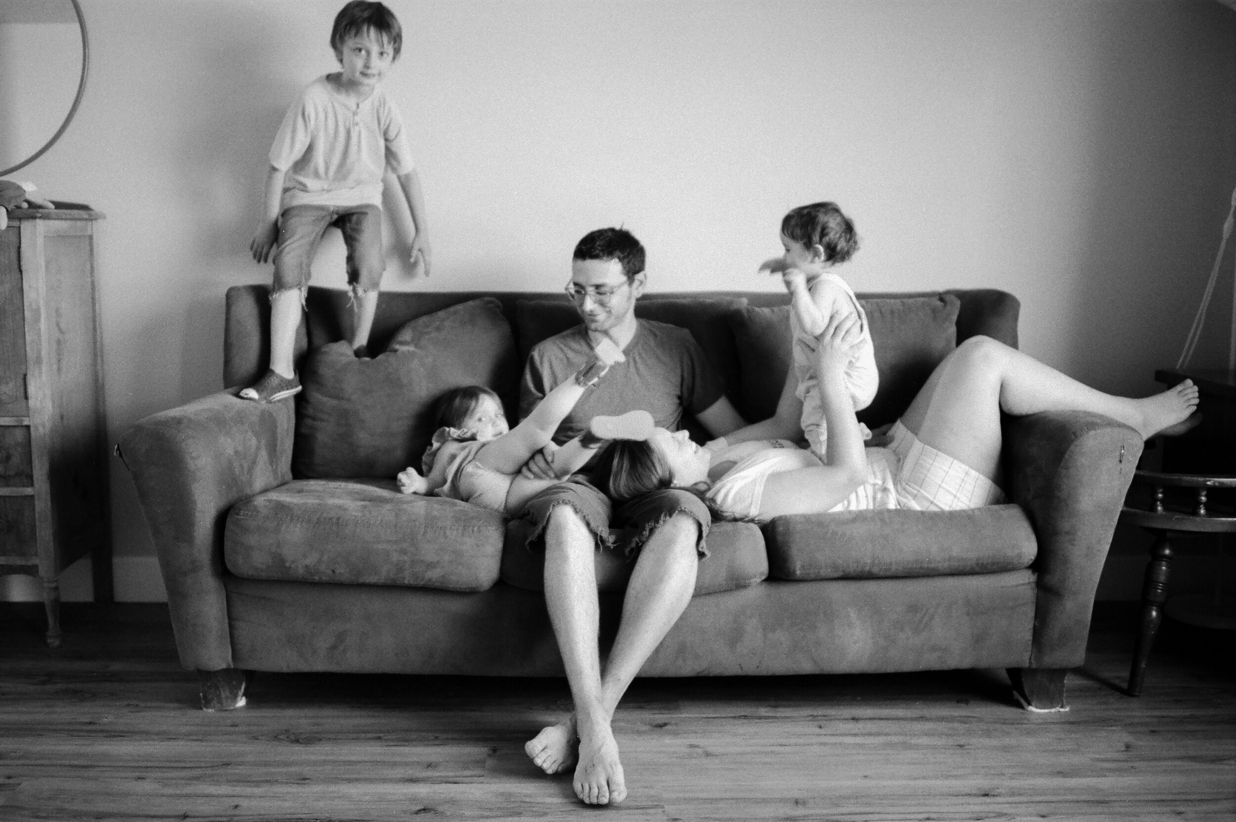 black and white film family sitting on couch