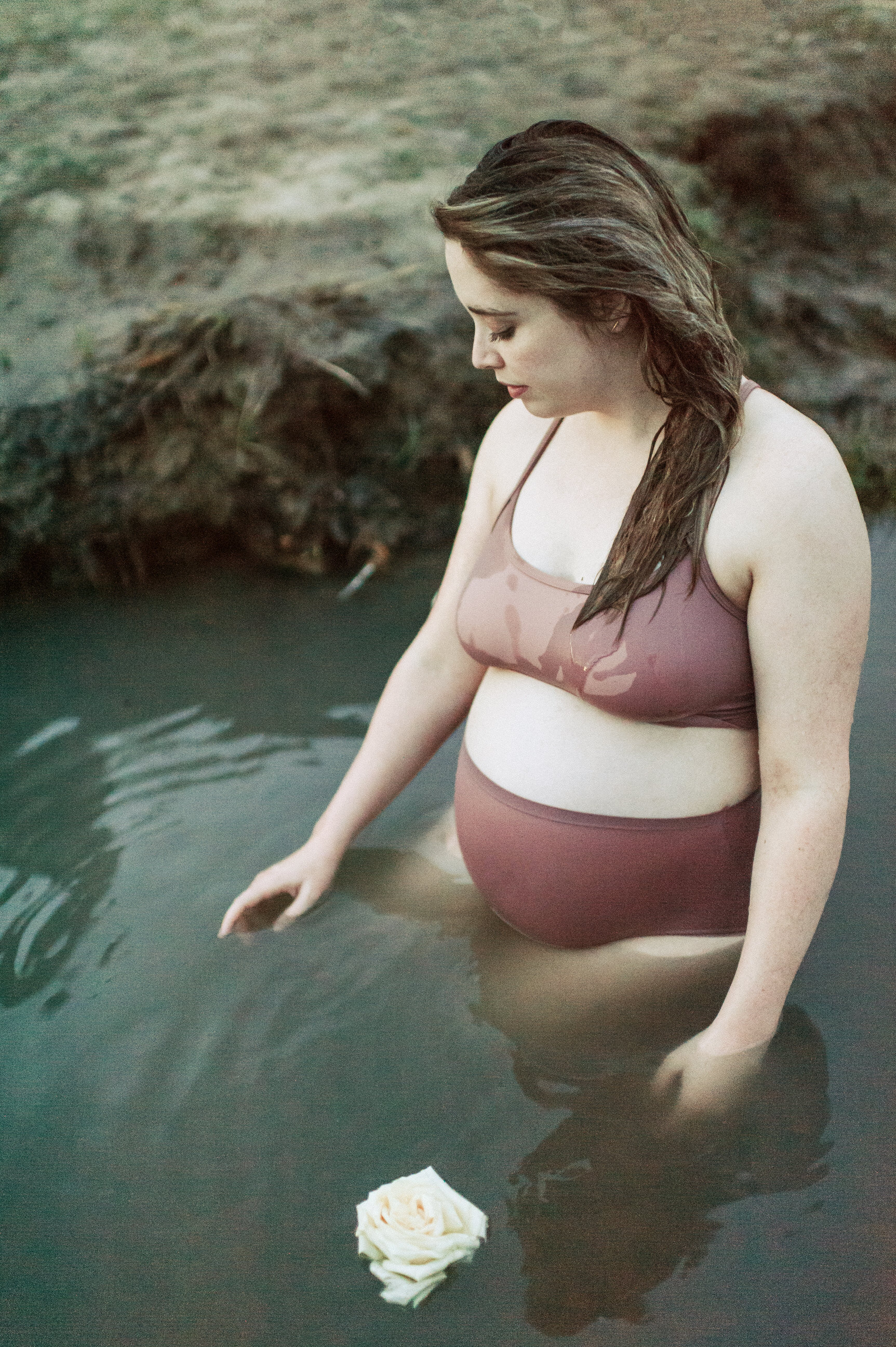 pregnant mom standing in hot spring nude underwear