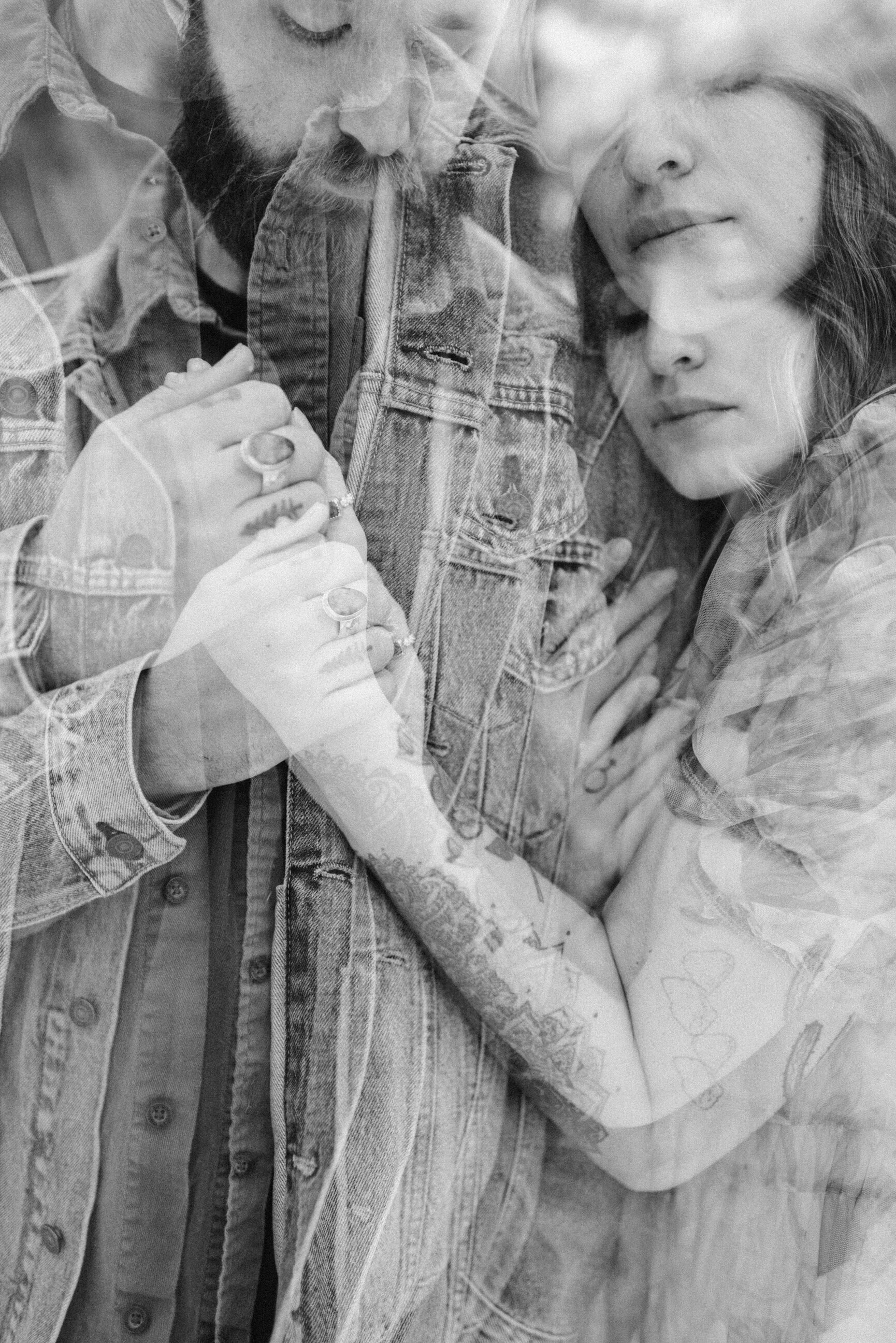double exposure in black and white of couple hugging with faces close together