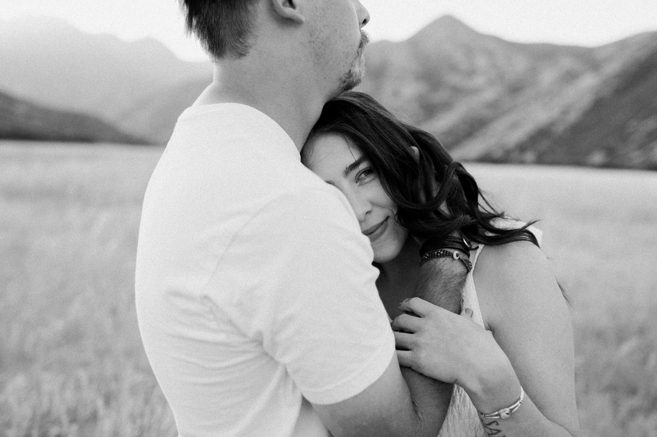 woman lying on man's chest his hand in her hair