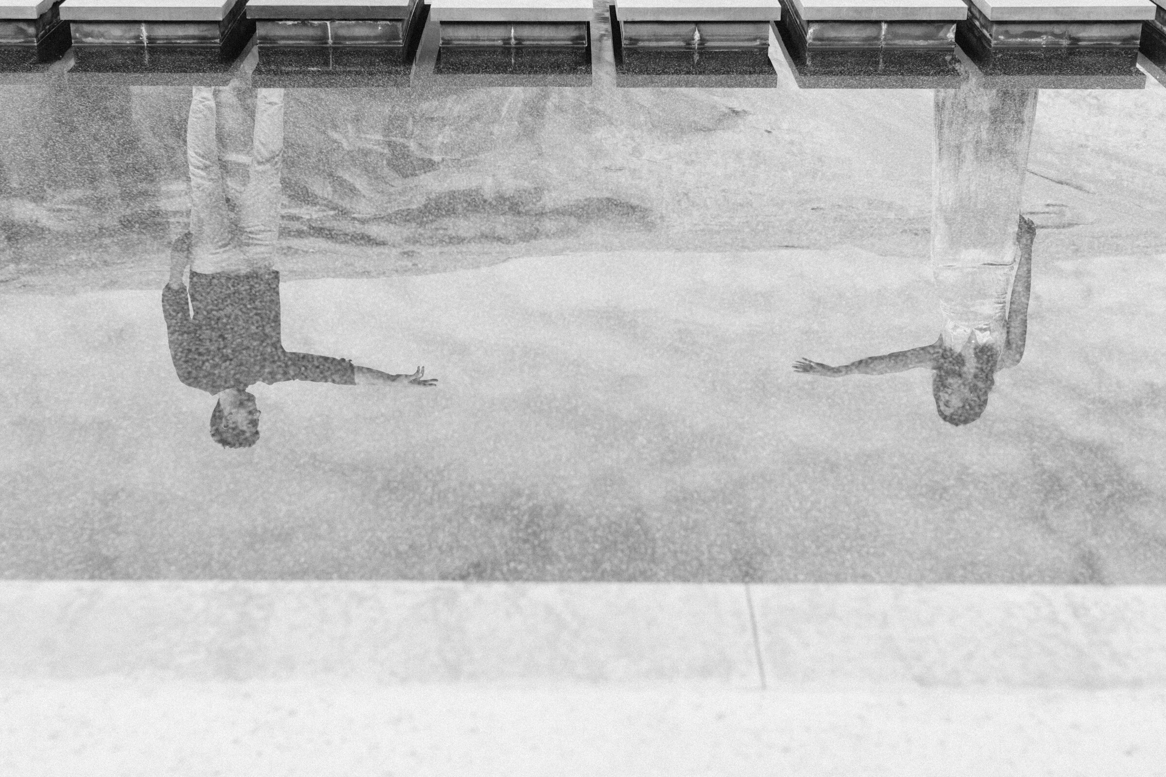 amangiri resort couple reflection in spa water reaching hands toward each other