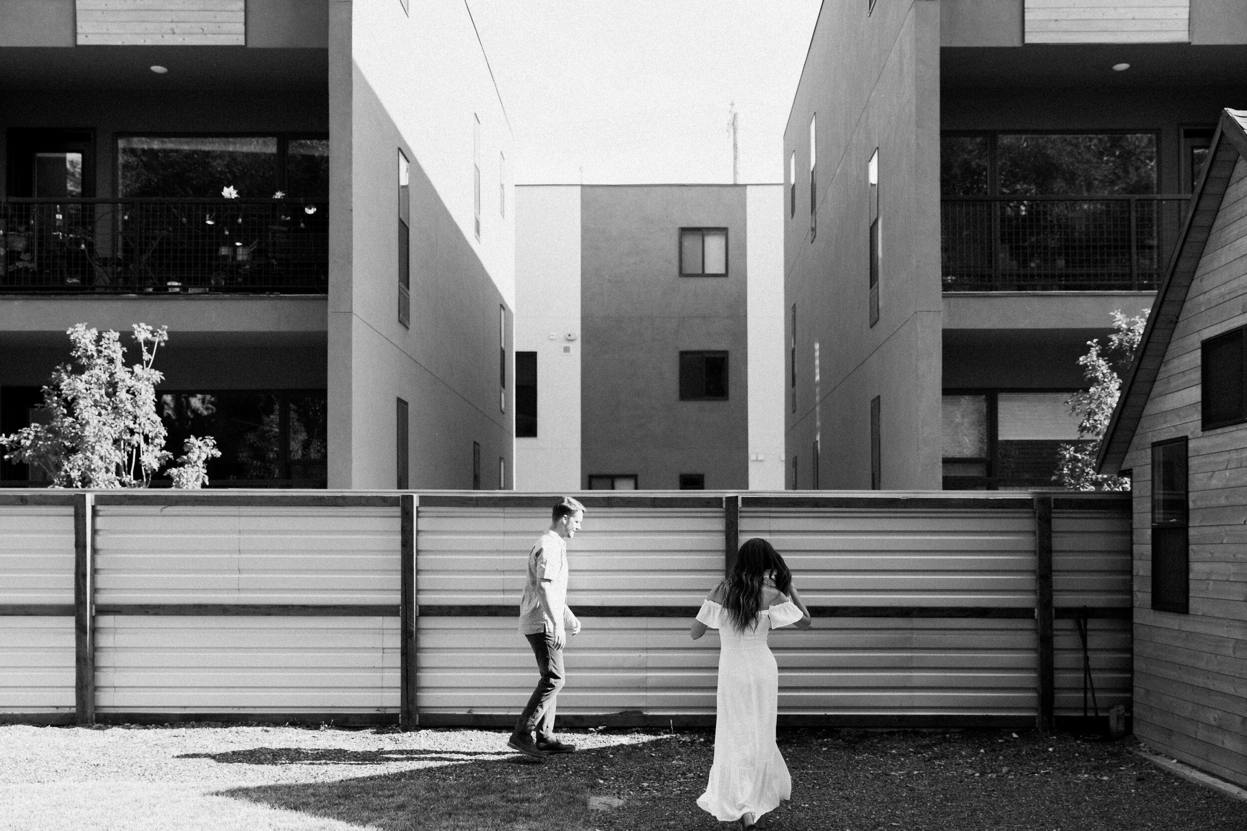 male female couple in bridal attire industrial buildings in background