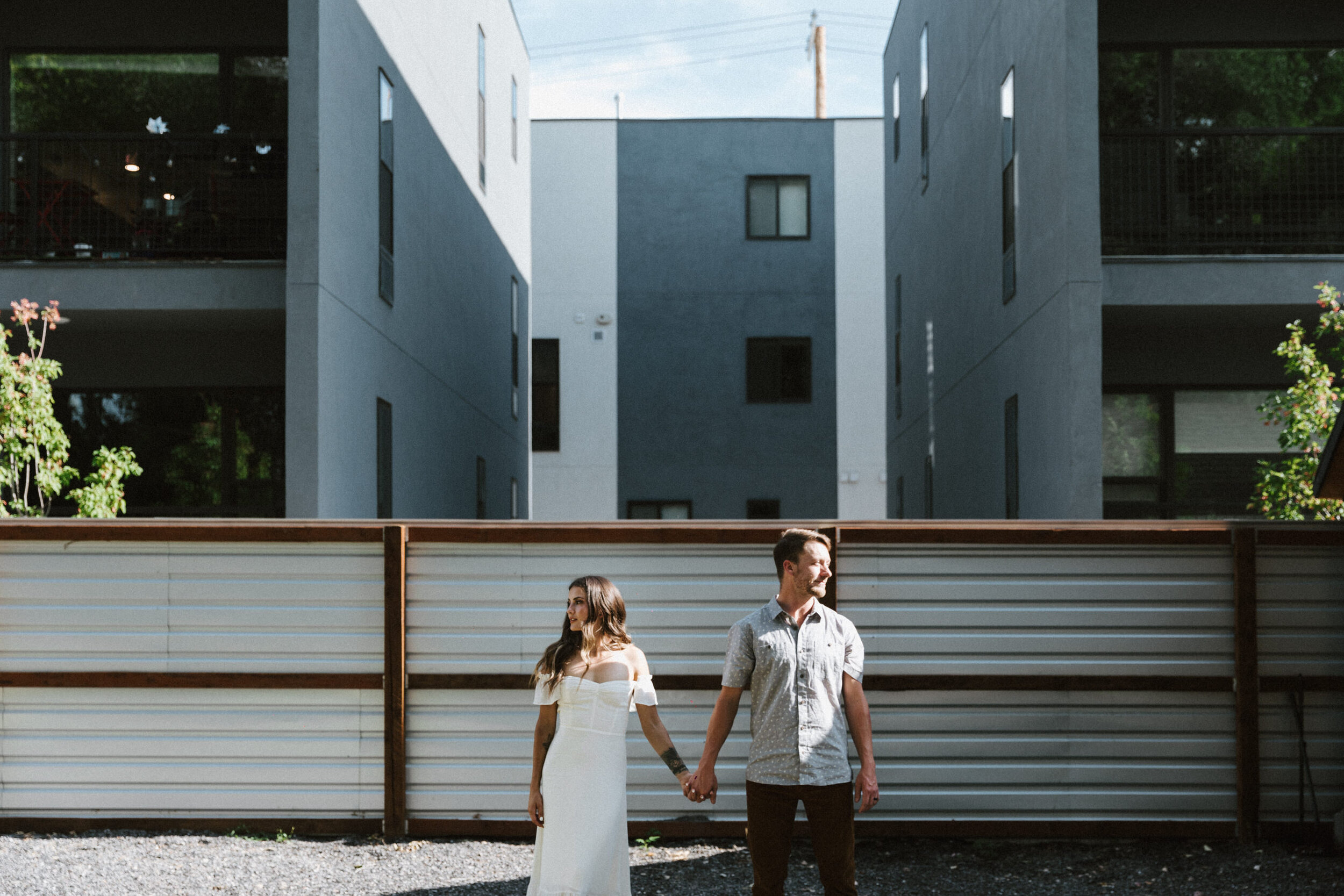 male female couple in bridal attire industrial buildings in background