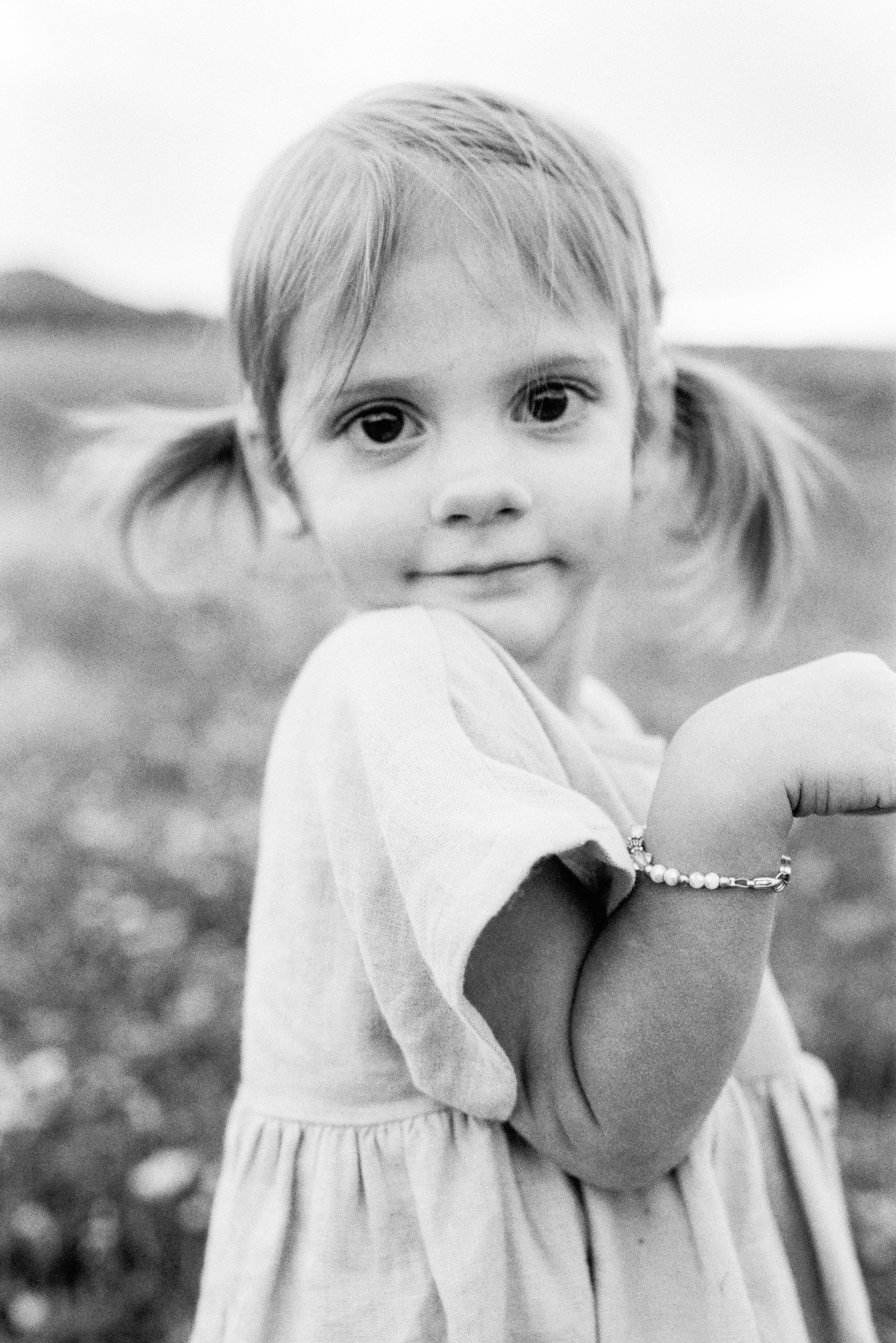 little girl with pigtails looking at camera