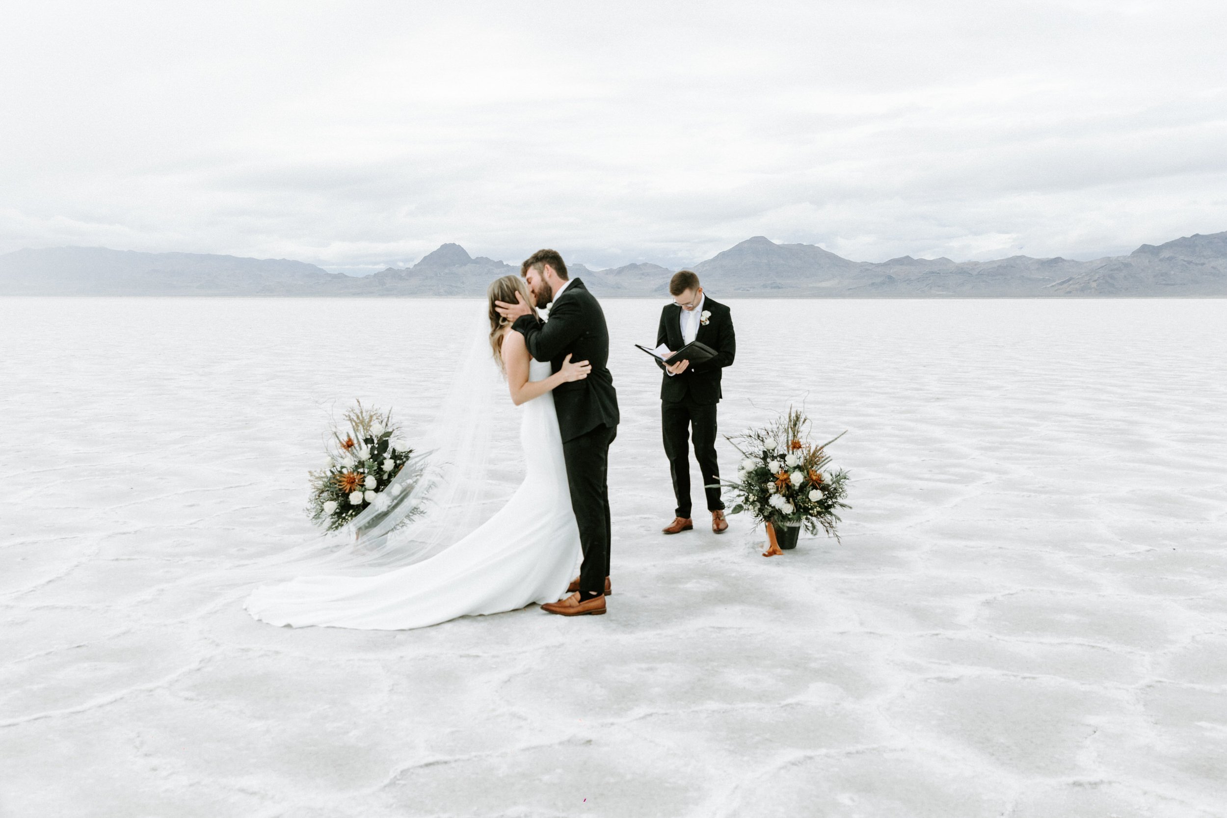 couple kissing at altar wedding on salt flats