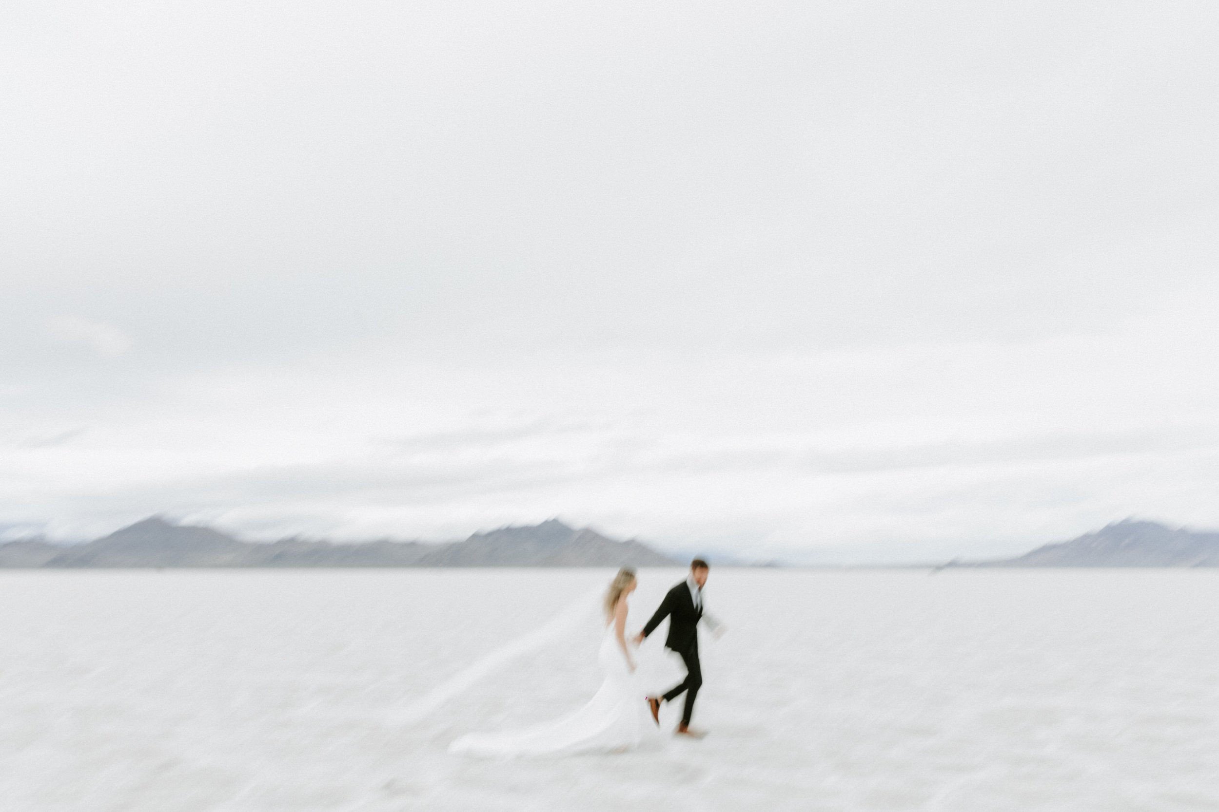 salt flats wedding couple running holding hands