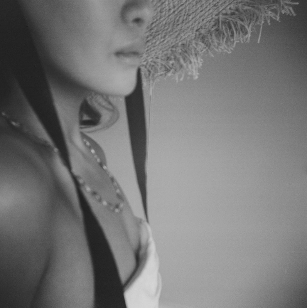 black and white holga photo of woman of color in straw hat