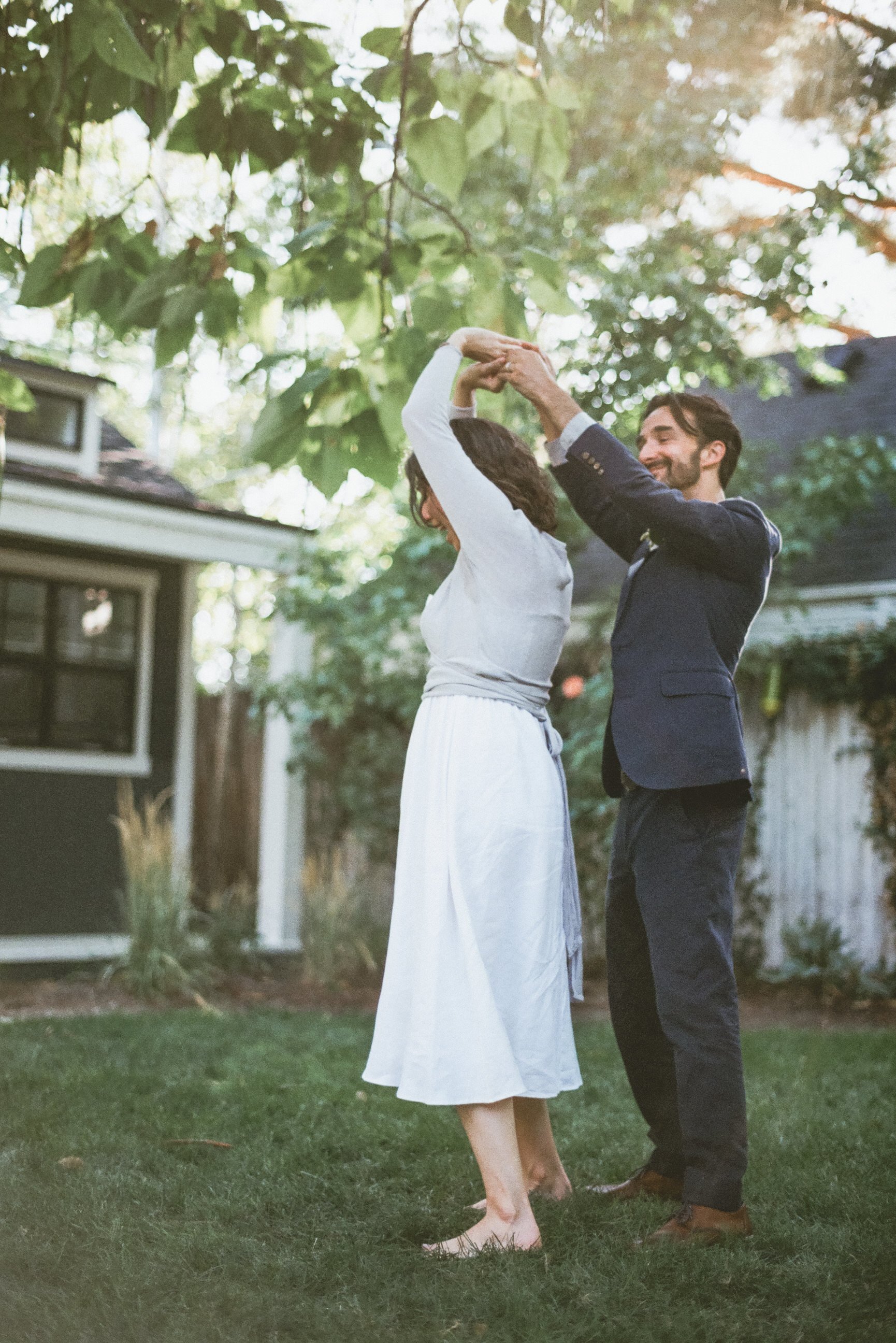 bride and groom first dance in Jewish traditional style hands clasped bride walking under hands