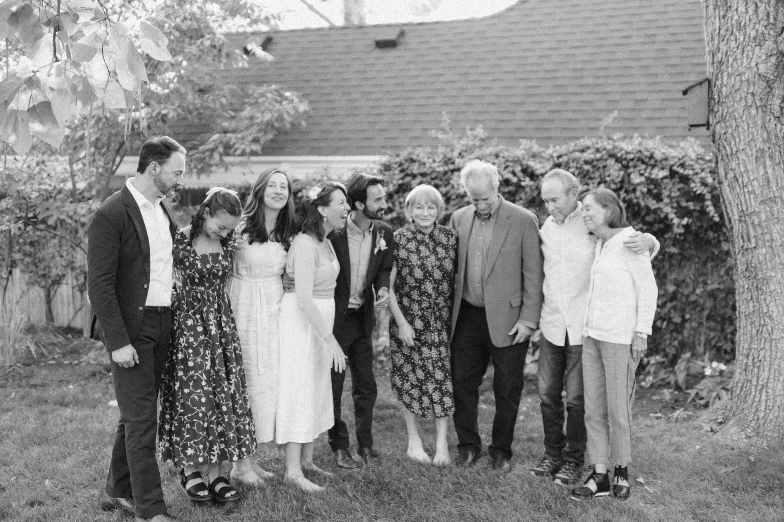 casual backyard wedding group photo in black and white