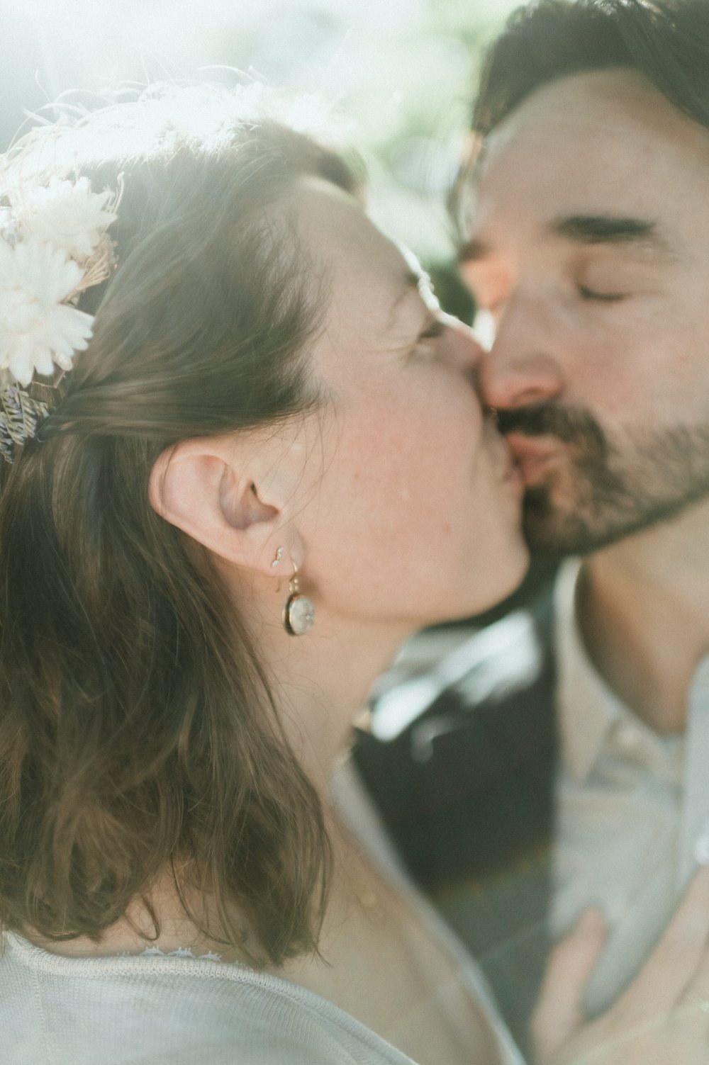 close up bride and groom faces together kissing