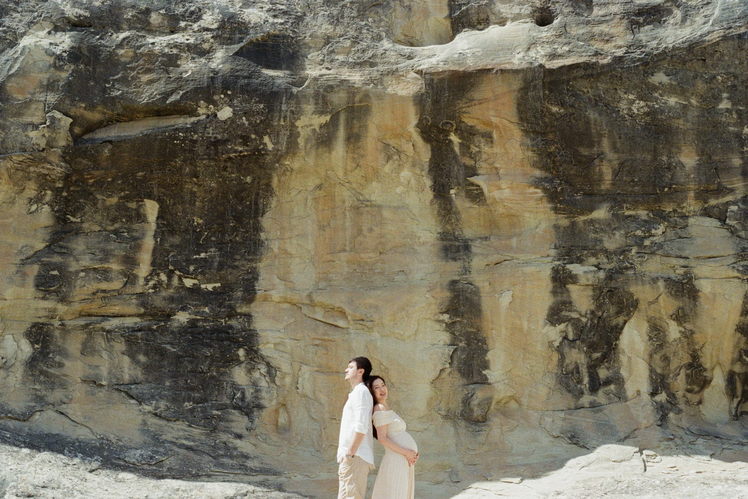 couple maternity photography at amangiri in front of desert rocks