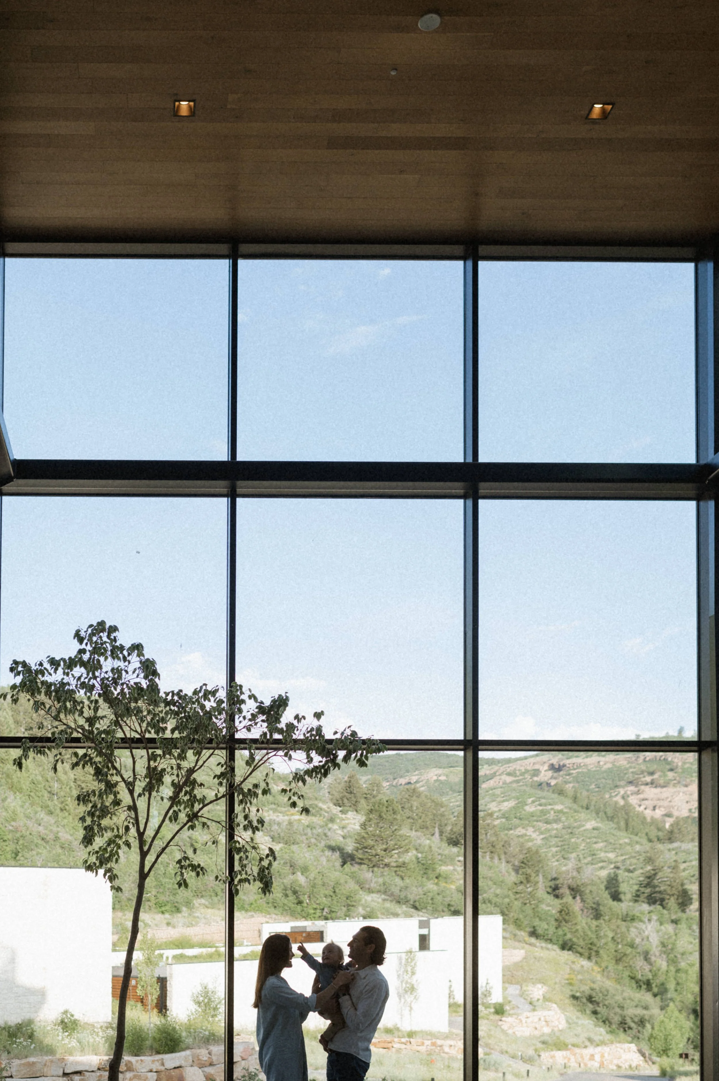 indoor family photo in front of large windows at the lodge at blue sky park city utah