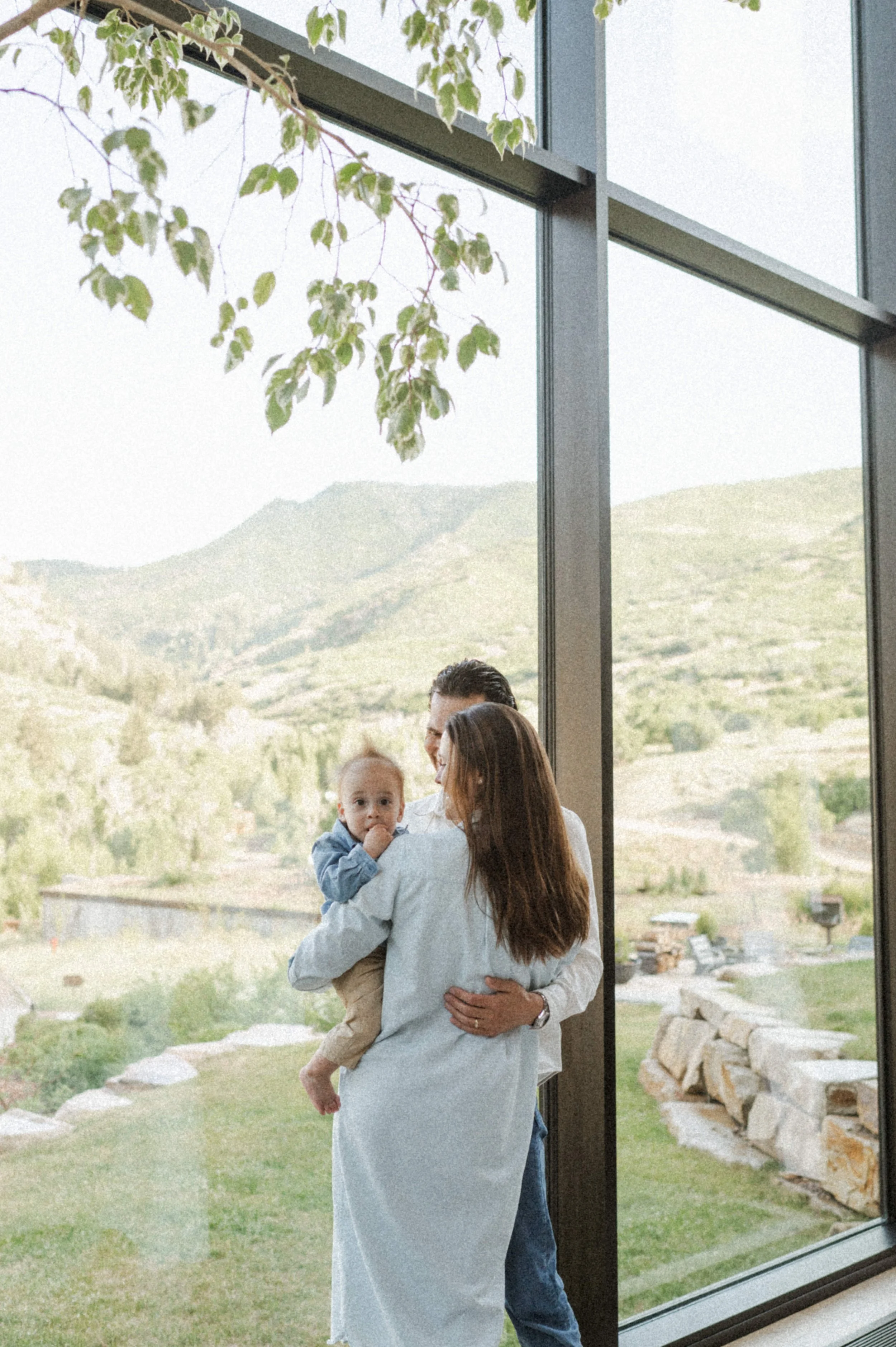 indoor family photo in front of large windows at the lodge at blue sky park city utah