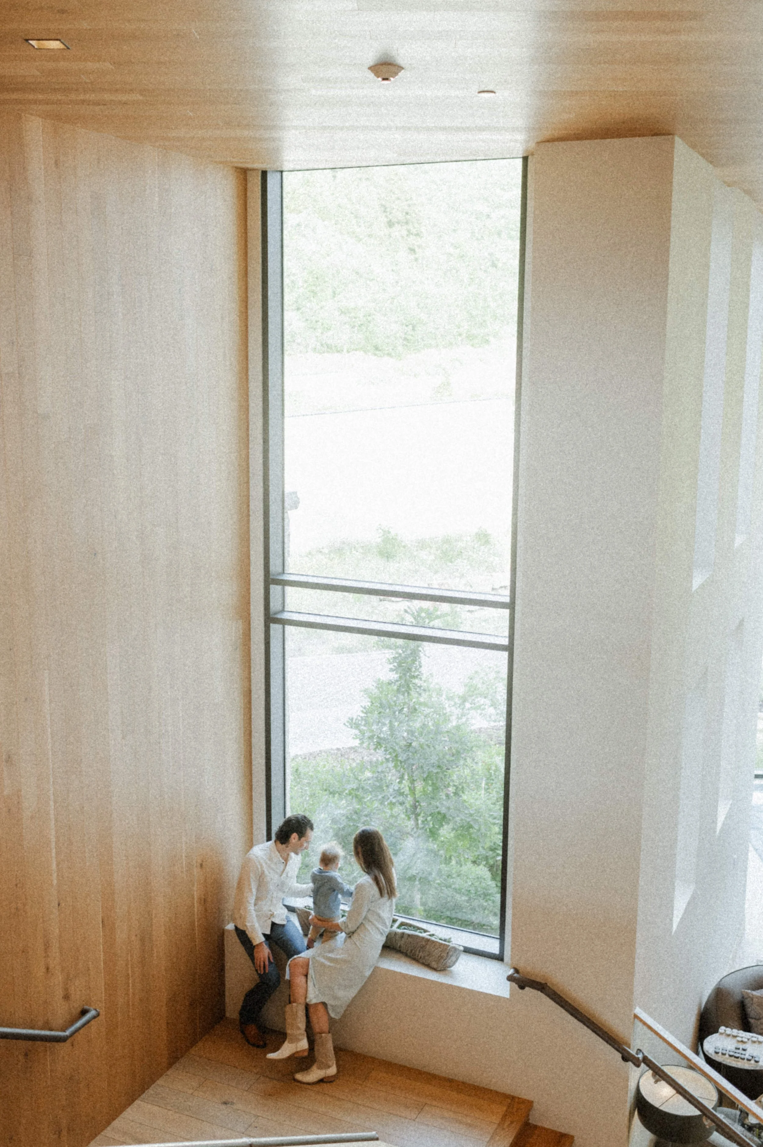 indoor family photo in front of large windows at the lodge at blue sky park city utah