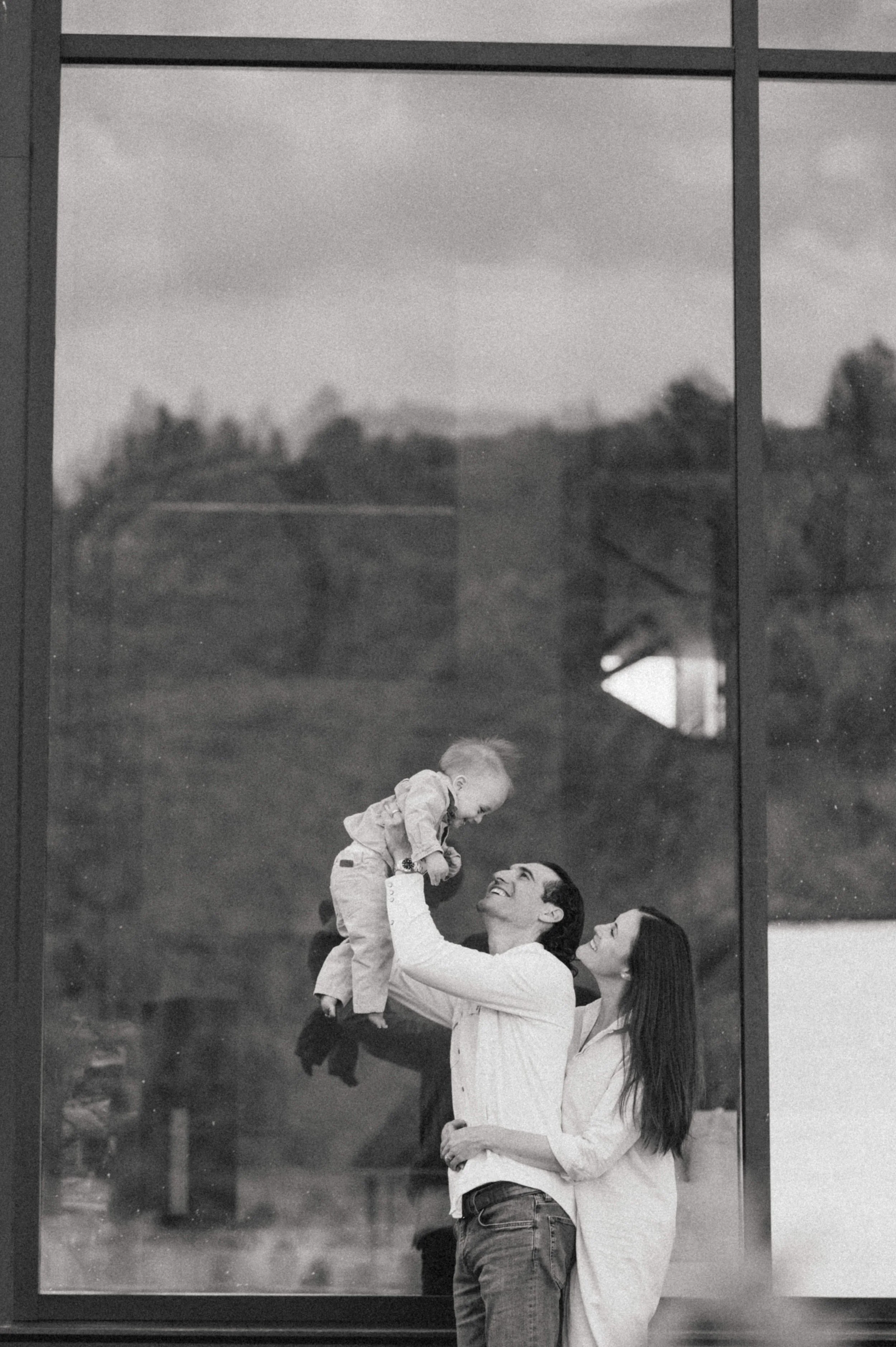 outdoor mountains family photo in front of large windows at the lodge at blue sky park city utah
