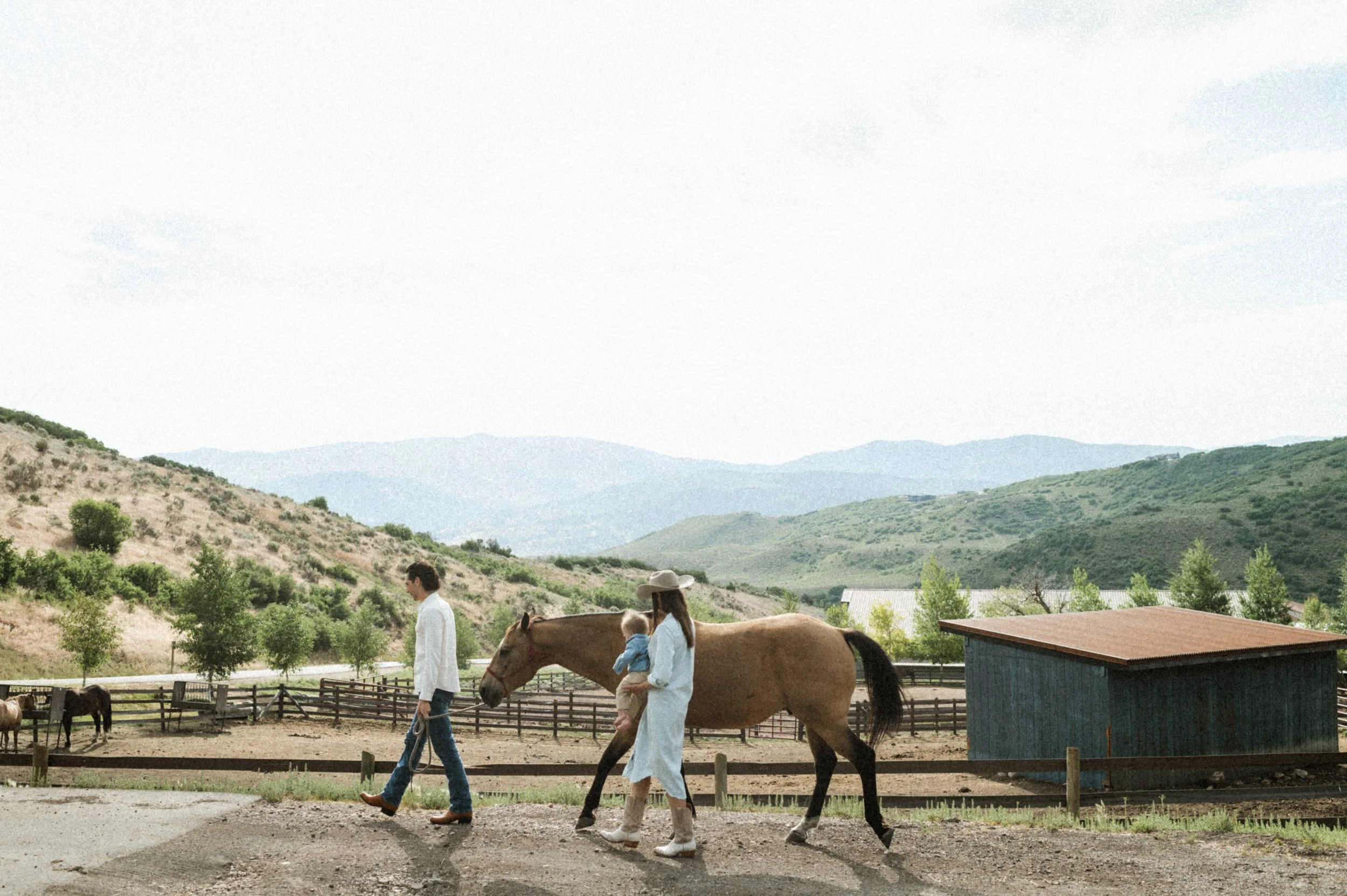 family photo with horses and barn at the lodge at blue sky park city utah