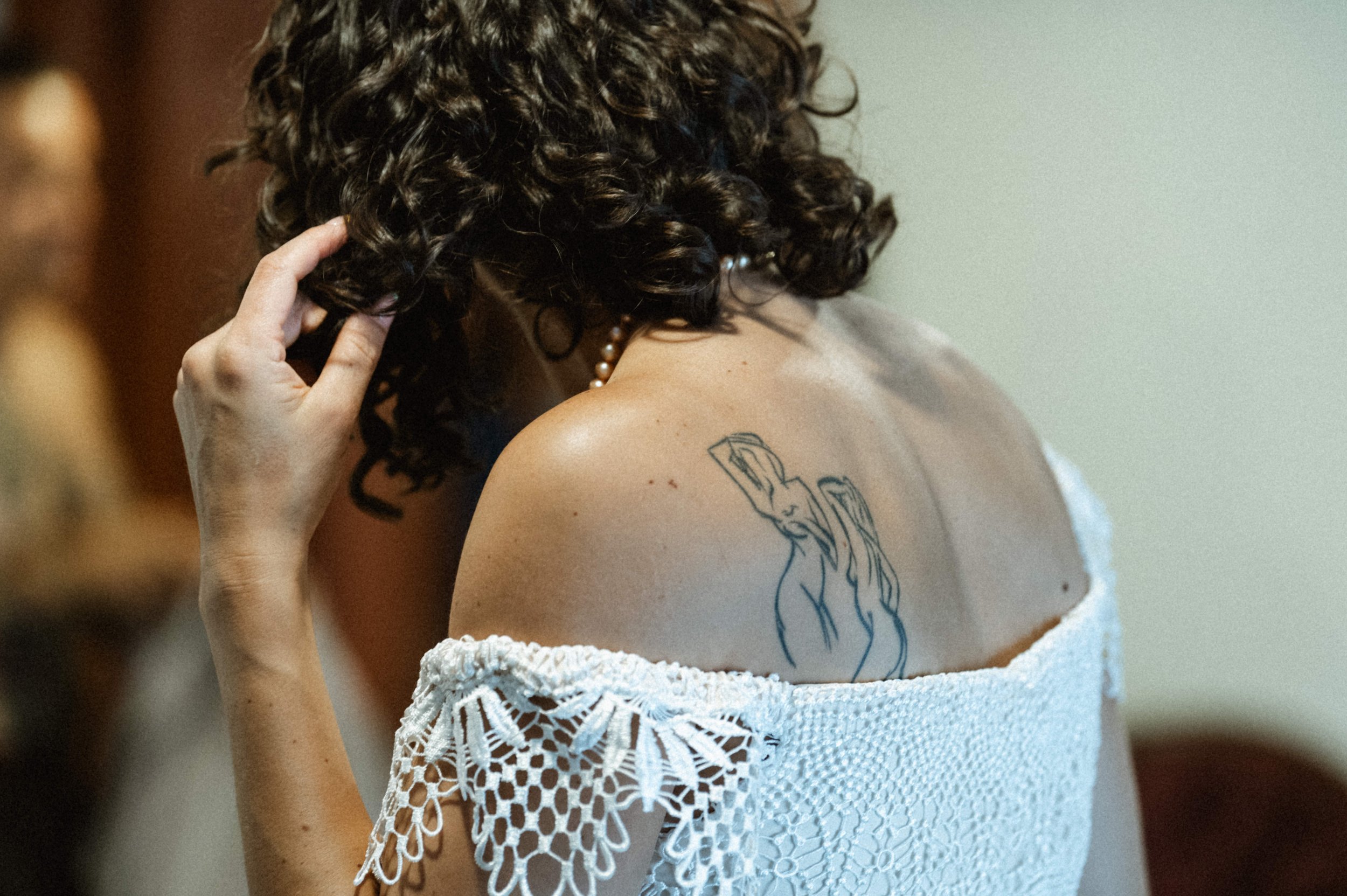 Bride in two-piece lace wedding dress with peek-a-boo waist at Ember wedding venue, Salt Lake City