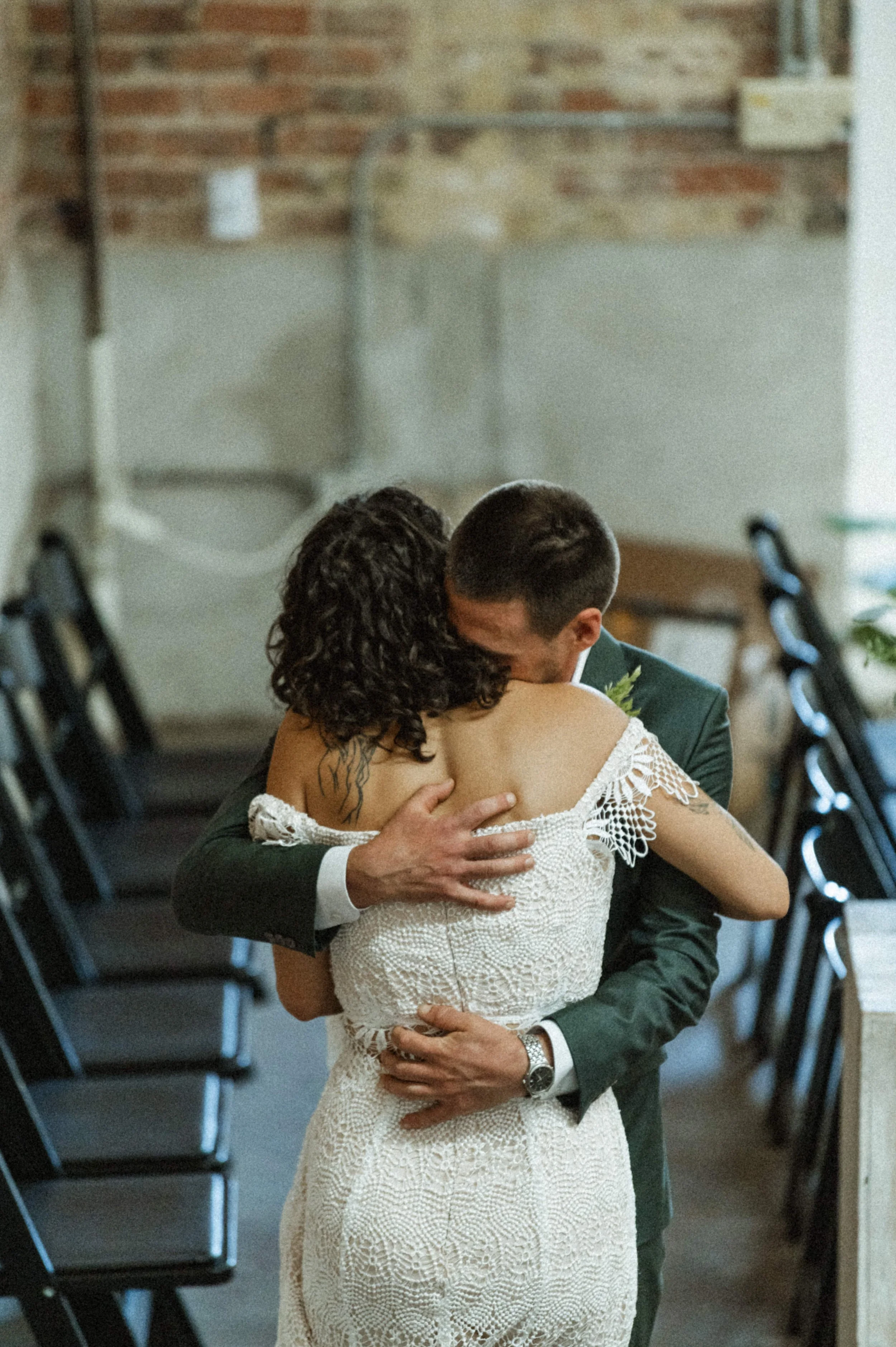 Bride and groom portrait against industrial brick backdrop at Ember, downtown Salt Lake City