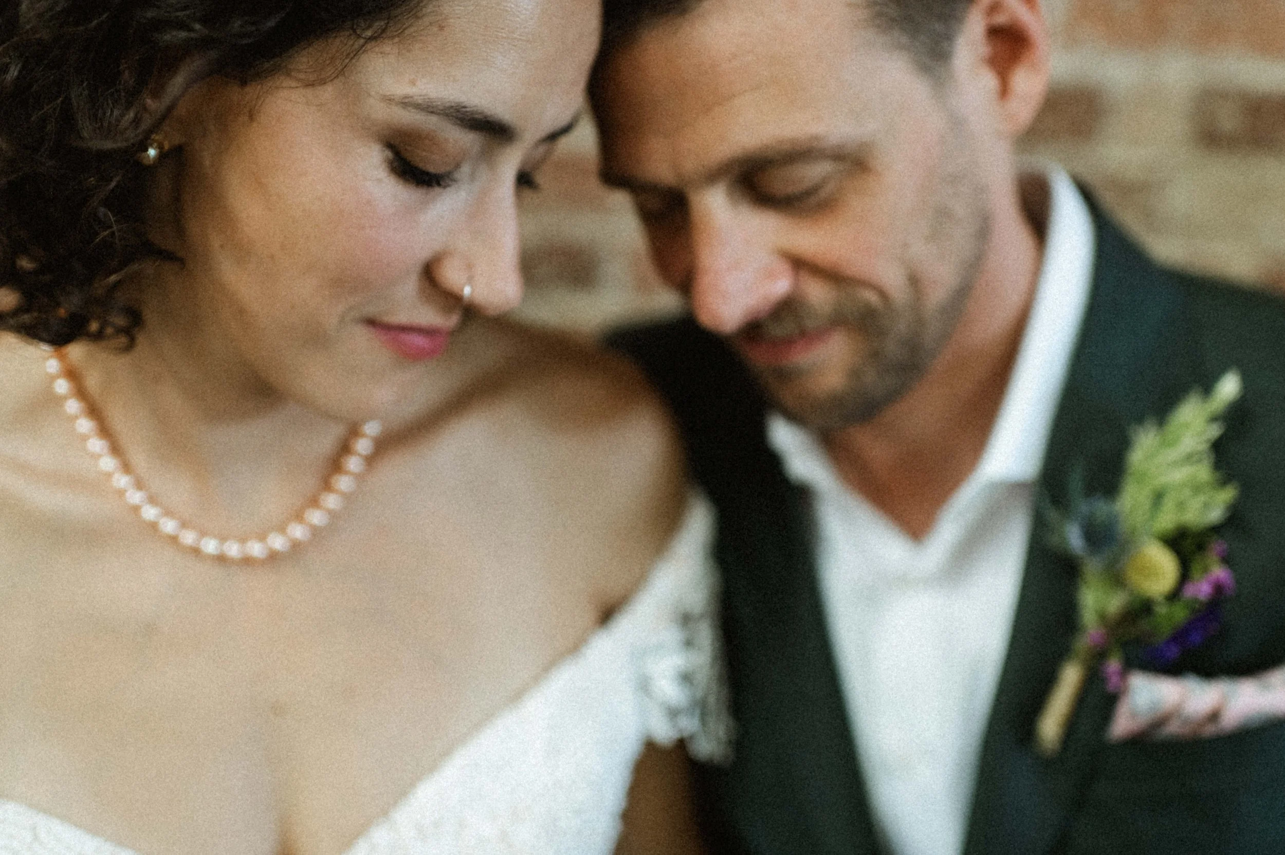 Bride and groom portrait against industrial brick backdrop at Ember, downtown Salt Lake City