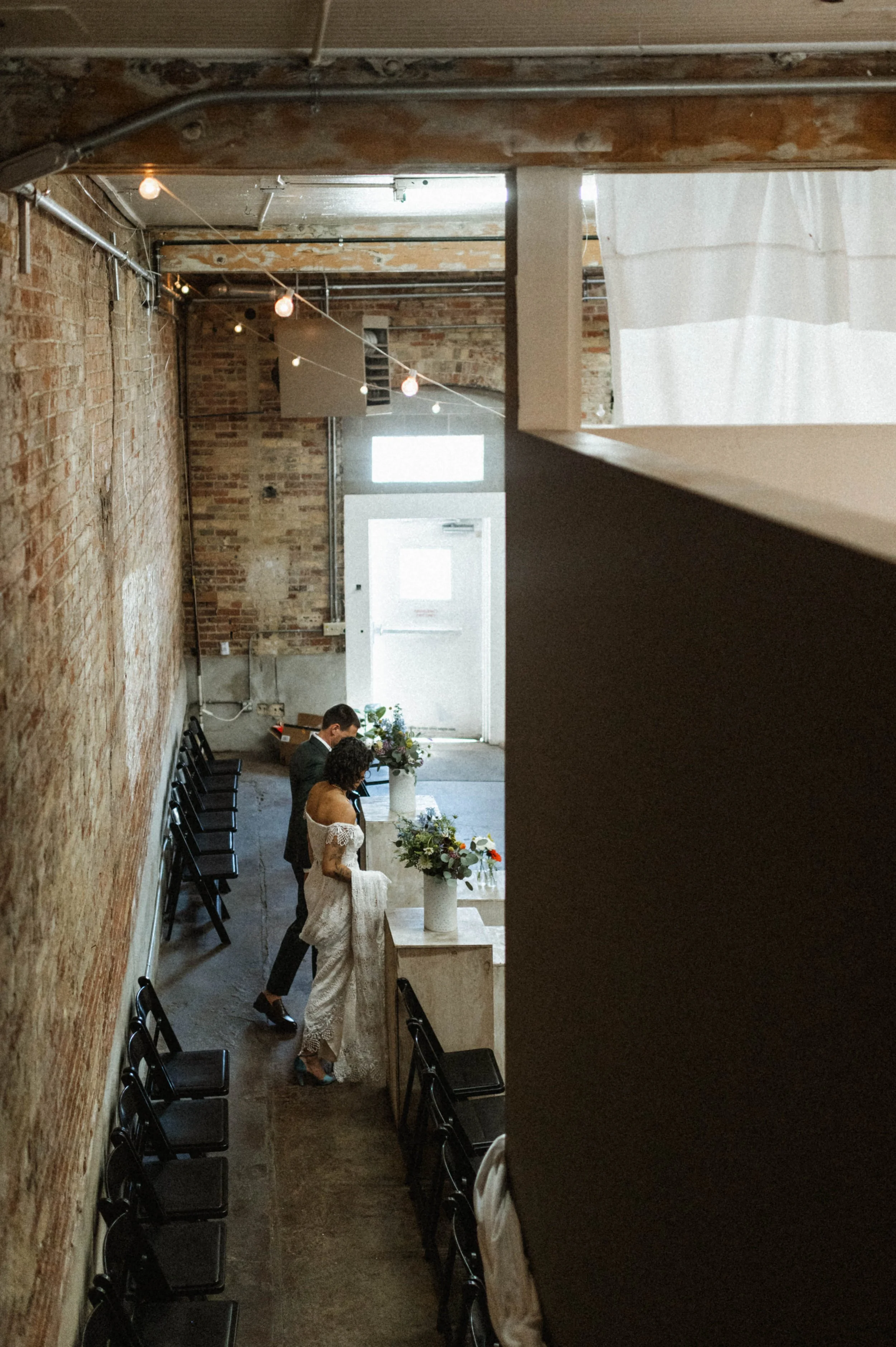 Bride and groom portrait against industrial brick backdrop at Ember, downtown Salt Lake City
