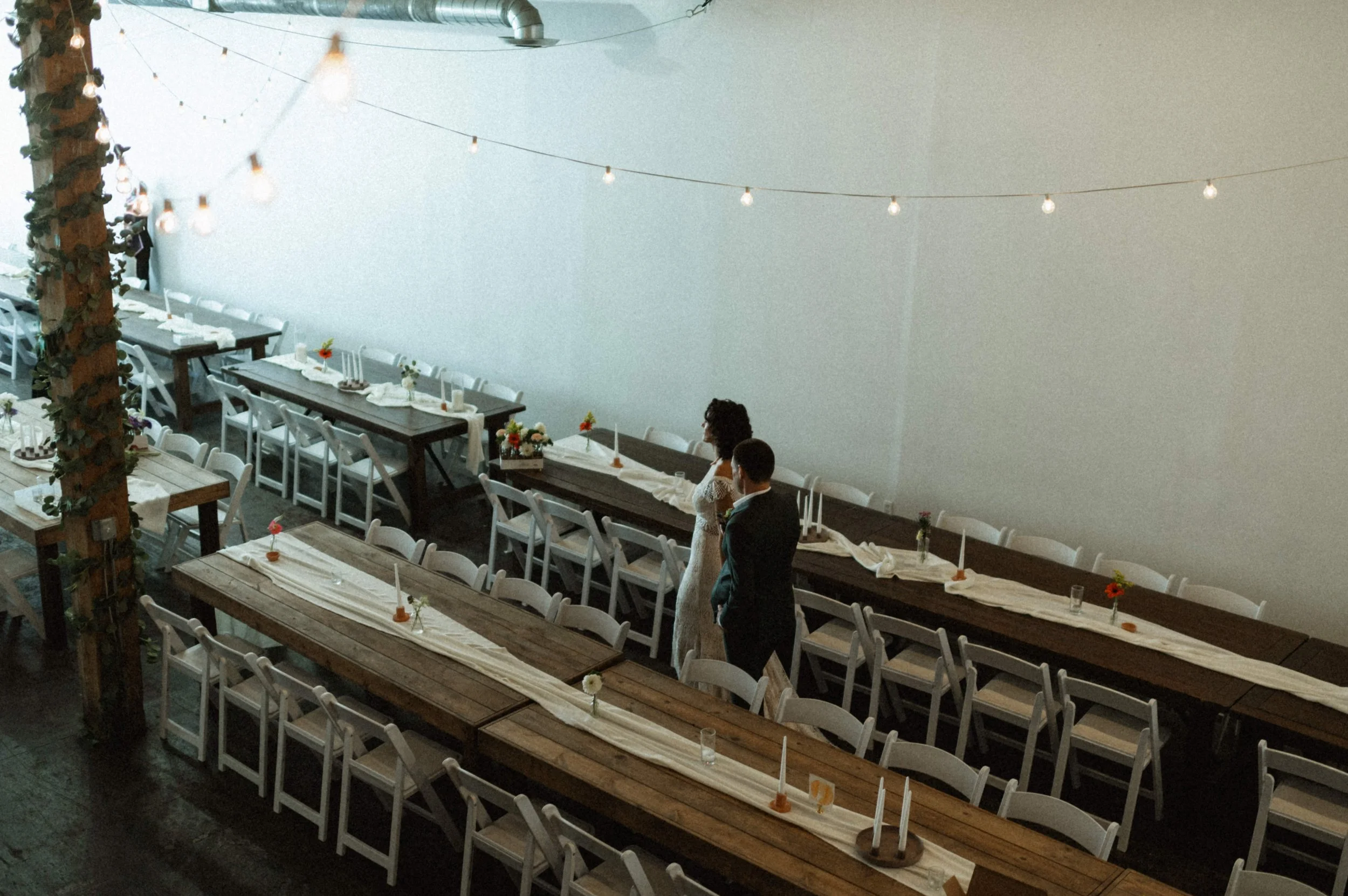 Bride and groom portrait against industrial brick backdrop at Ember, downtown Salt Lake City