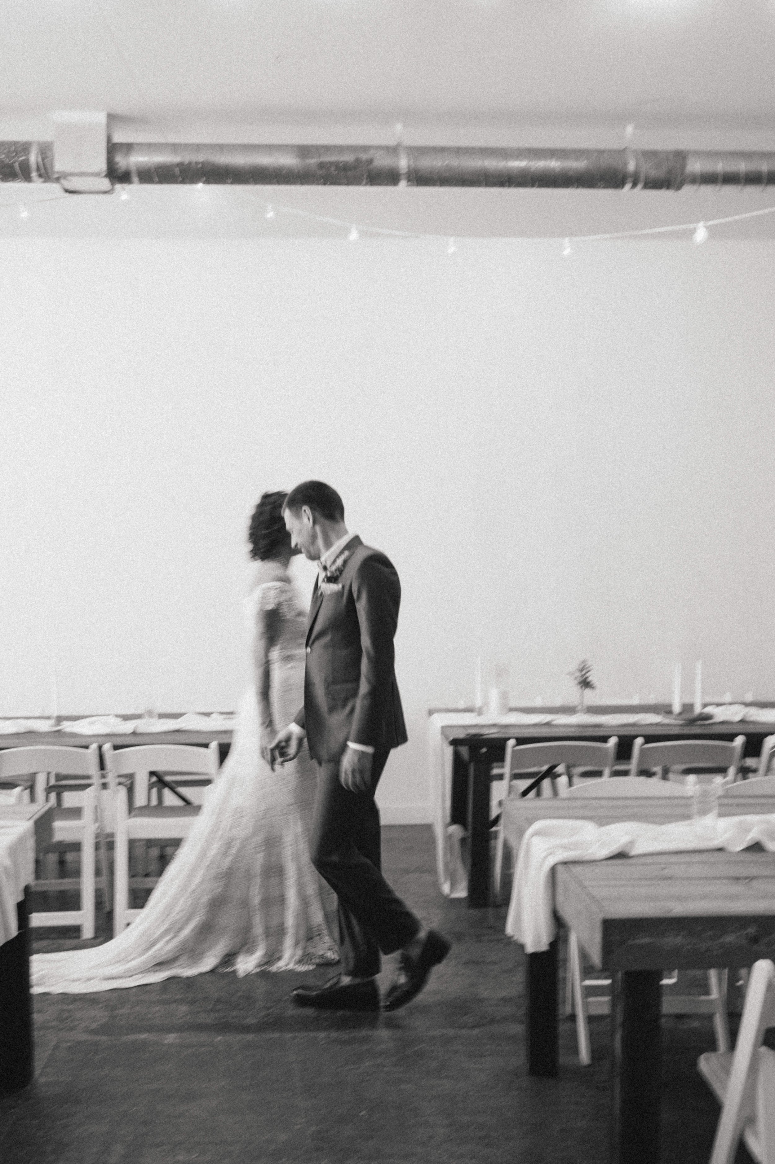 Bride and groom portrait against industrial brick backdrop at Ember, downtown Salt Lake City
